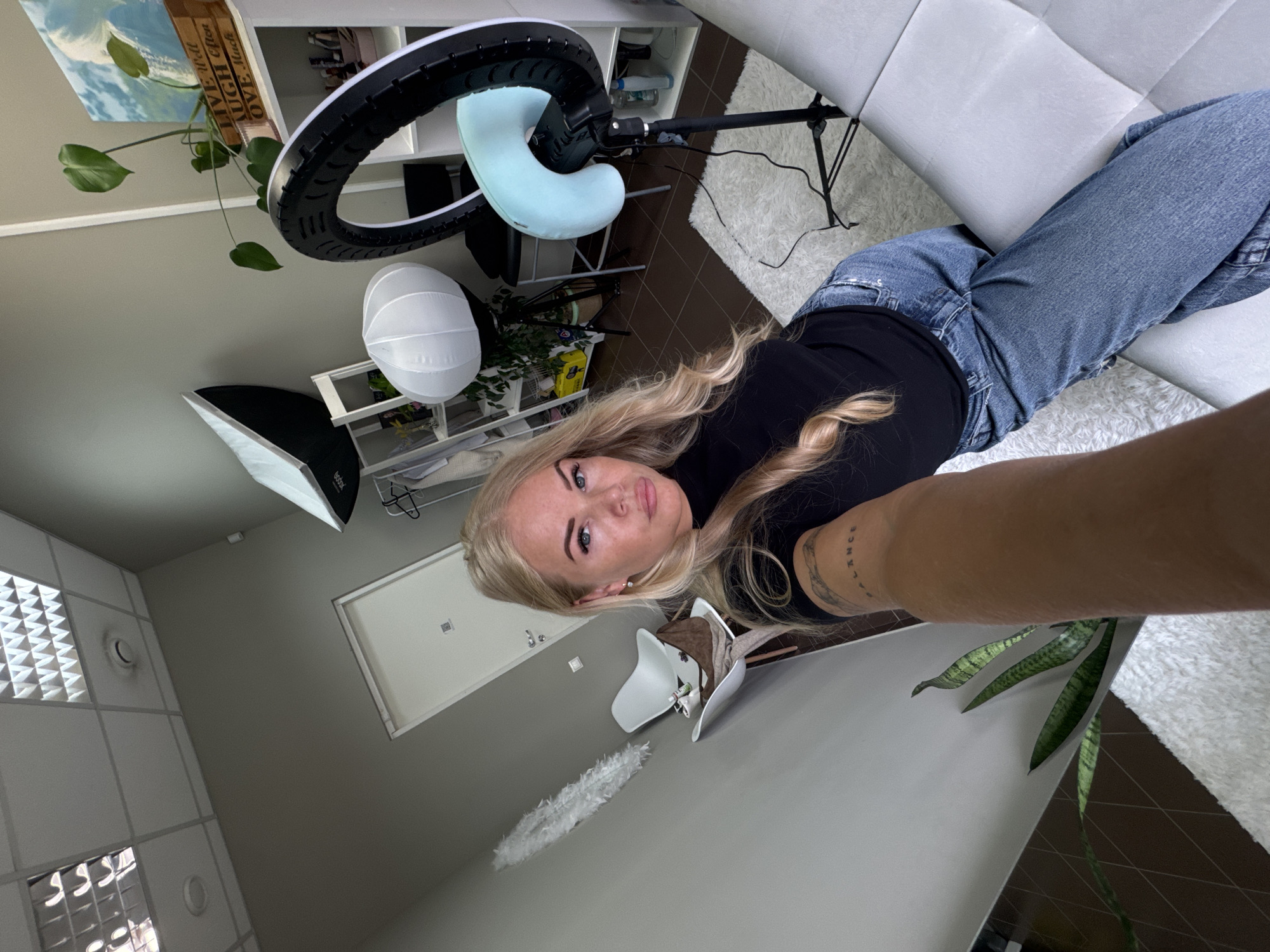 Woman documents photo session with professional lighting setup