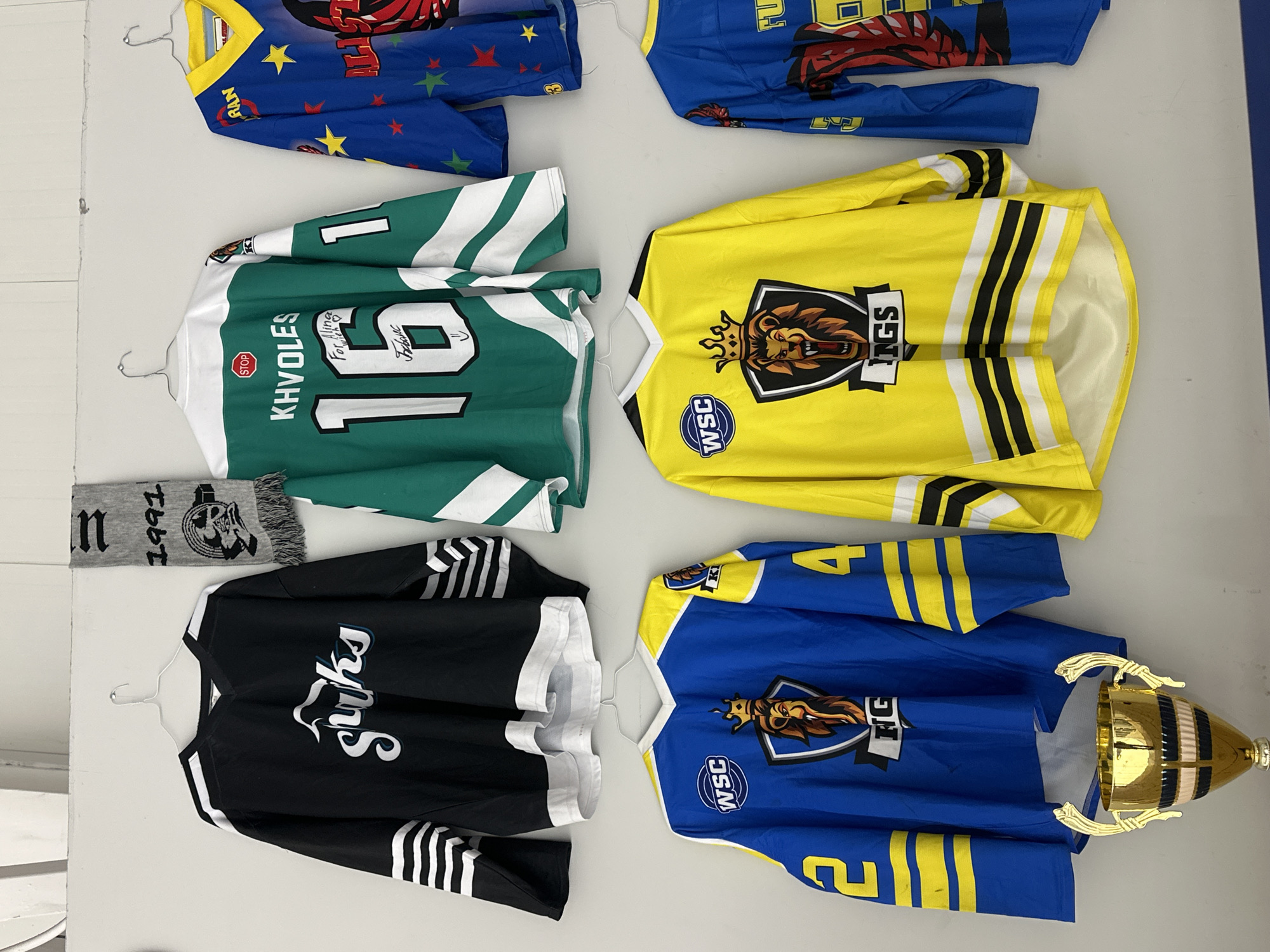 Hockey jersey collection displayed on wall in Tnuvot