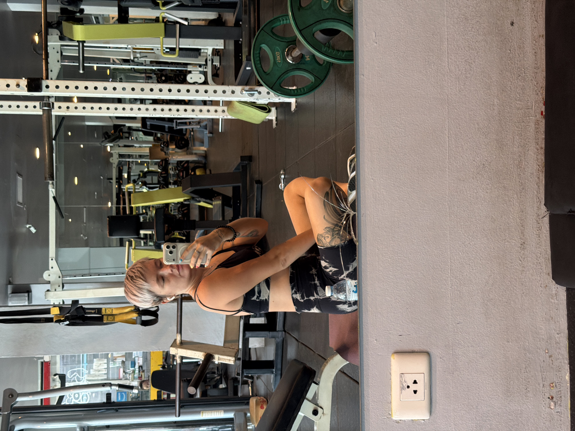 Woman takes gym mirror selfie in Thep Krasatti Thailand
