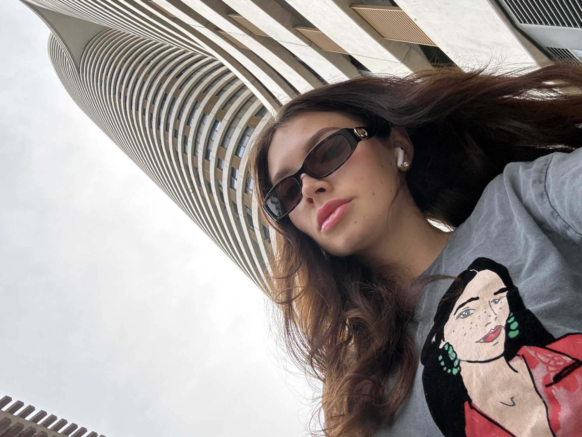 Woman photographed against curved building backdrop in Tel Aviv