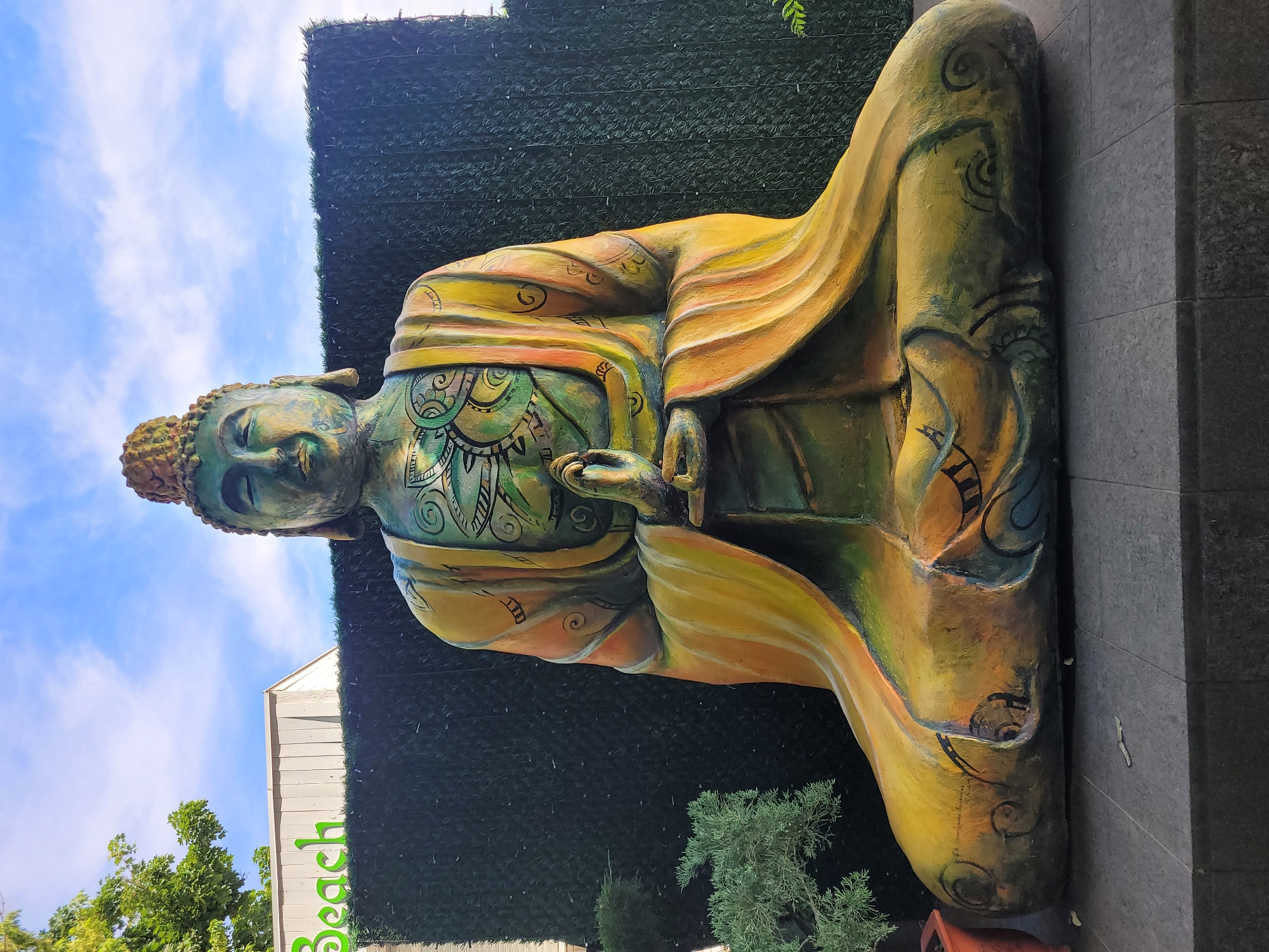 Beach day and resort vibes with a Buddha statue nearby