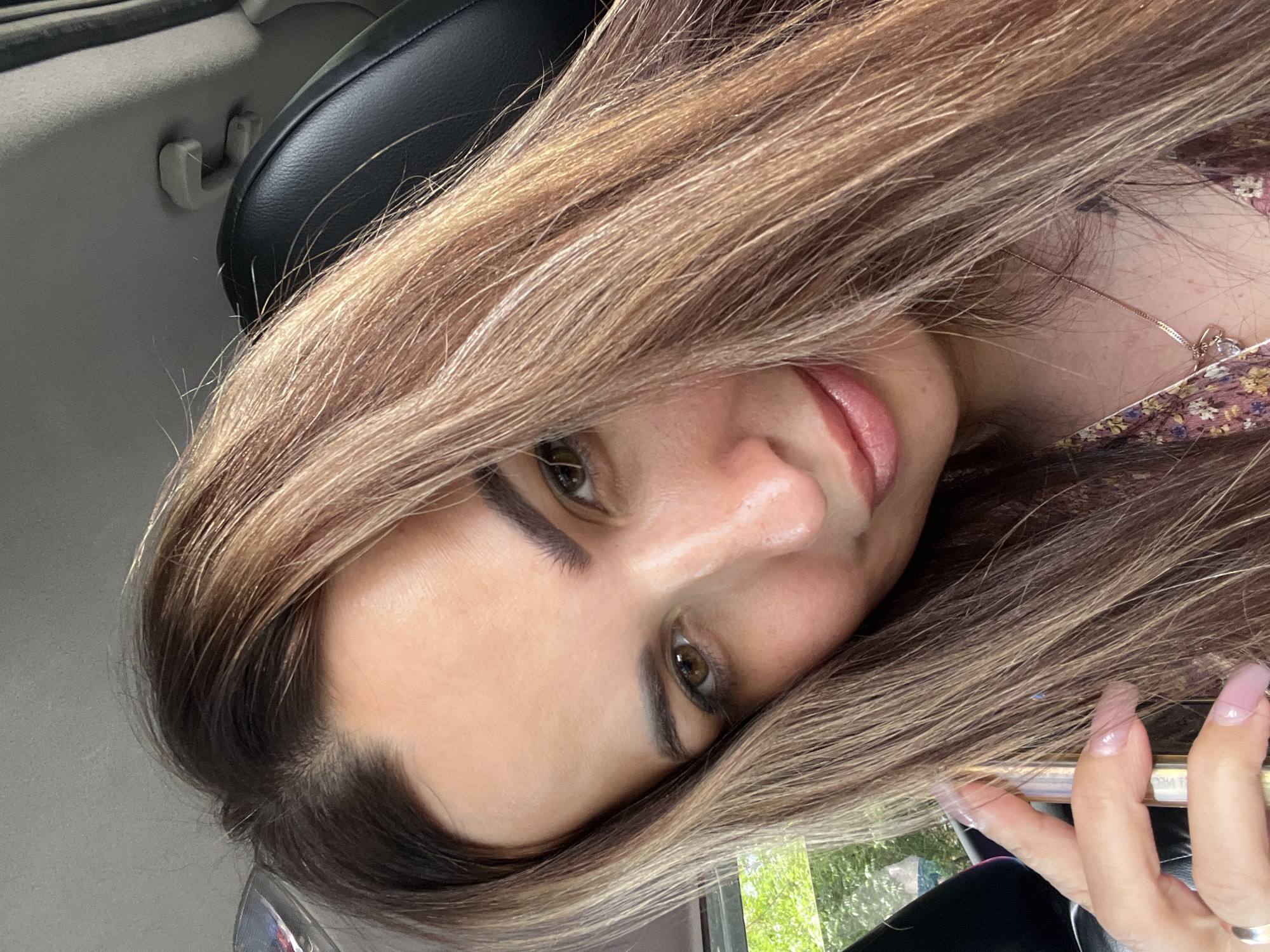 In a parked car with a book, a phone, and a floral dress