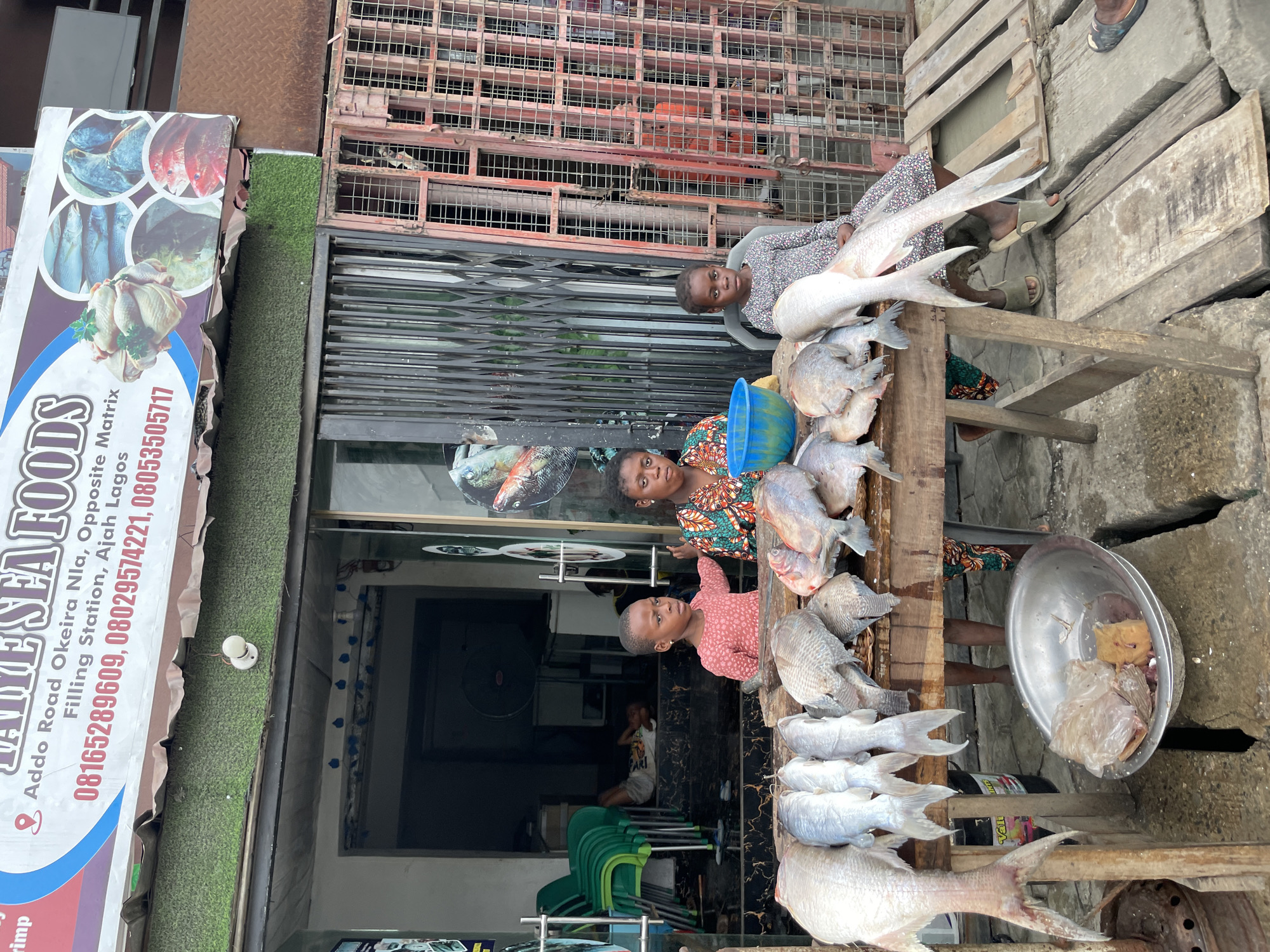 Street life and commerce along a busy Ado, Nigeria block