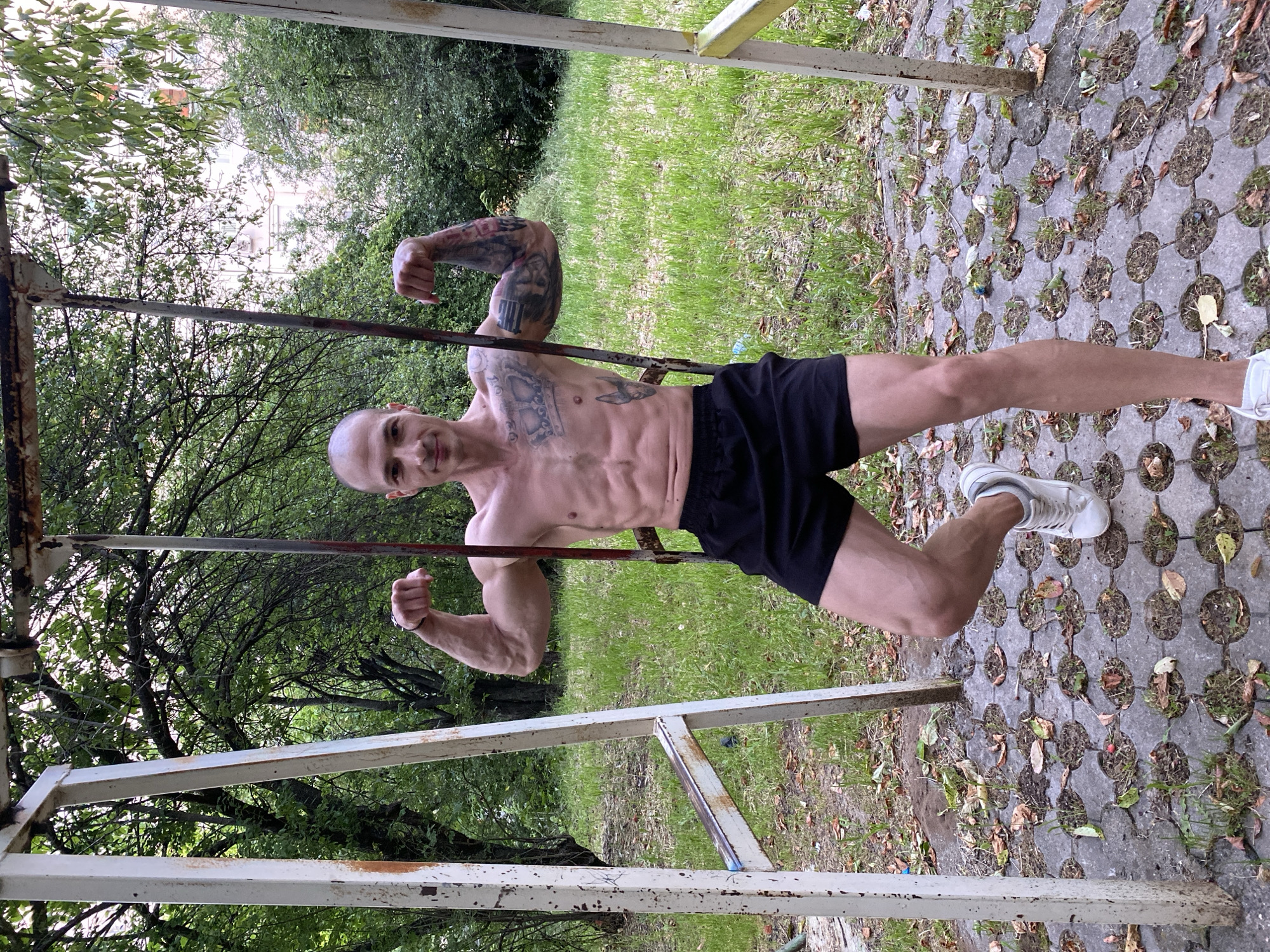 Man performs calisthenics workout on playground equipment in Bulgaria
