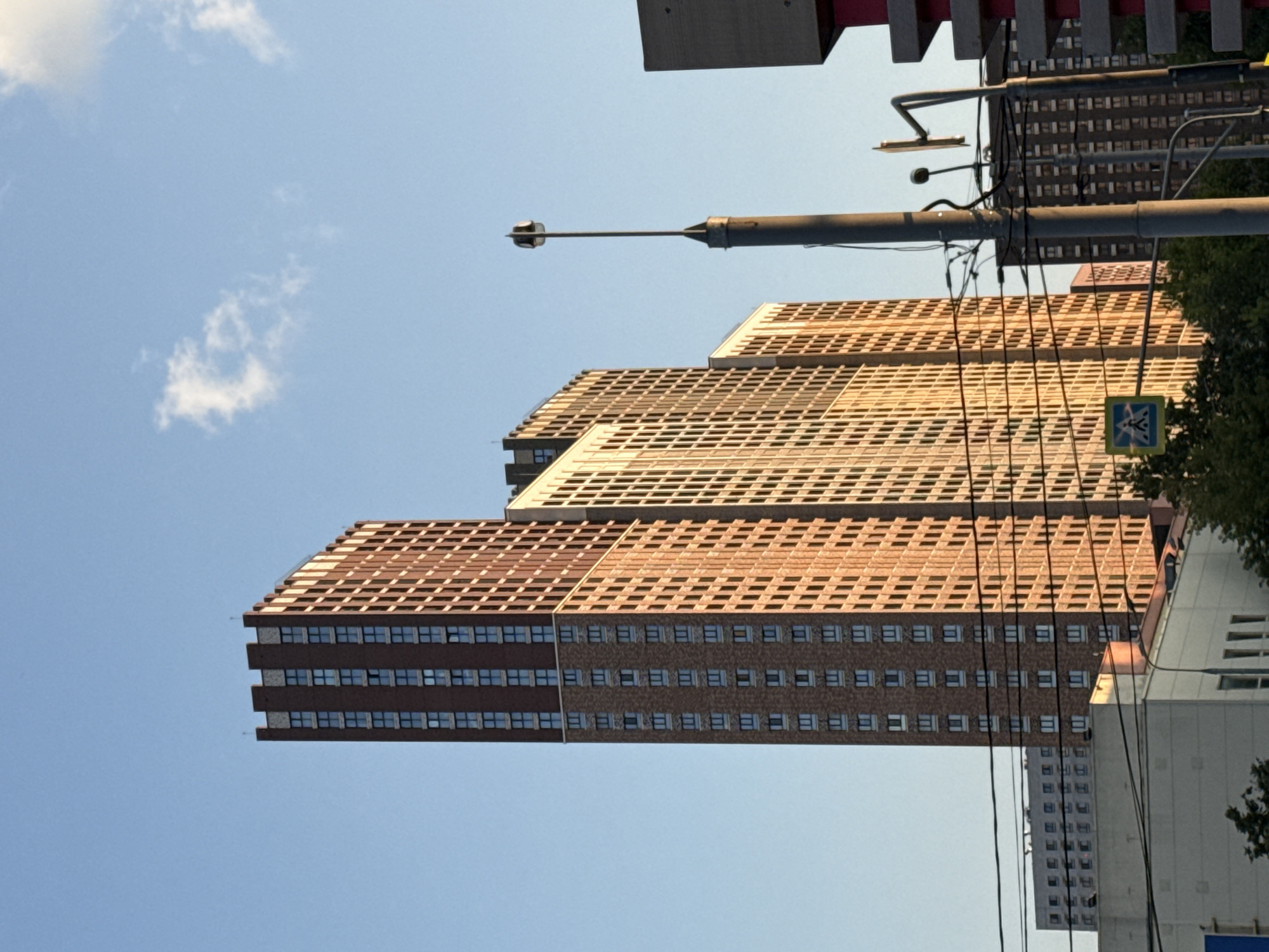 Golden hour light hits Moscow streets and modern apartment blocks