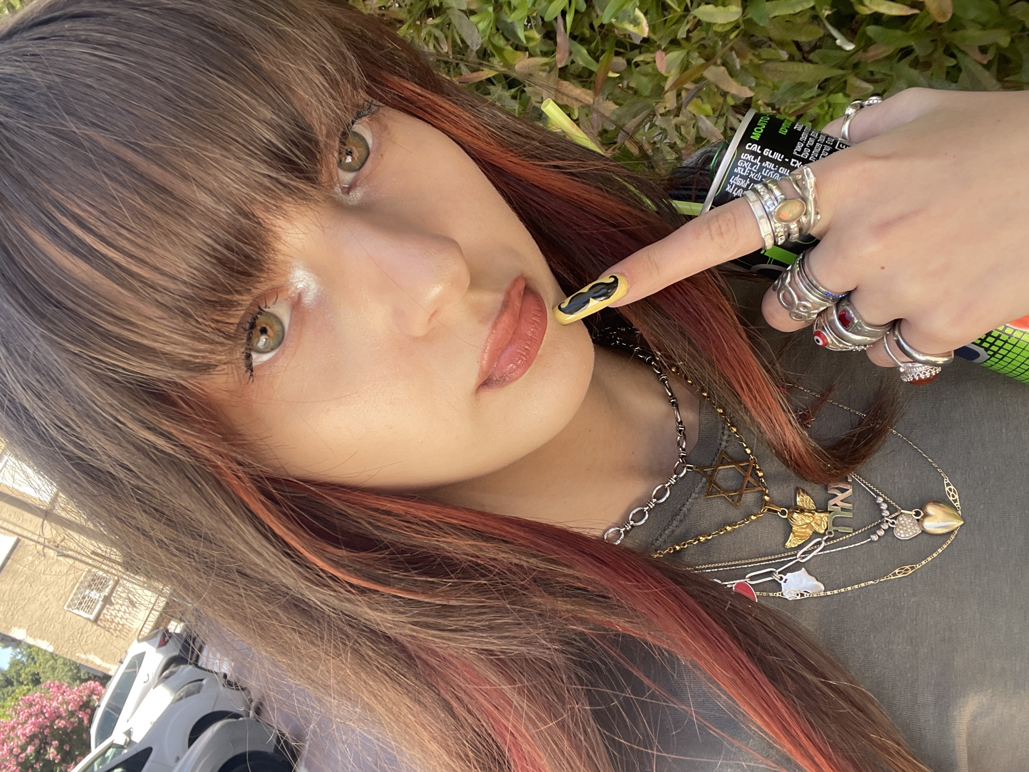 Woman enjoys energy drink in Raanana selfie moment