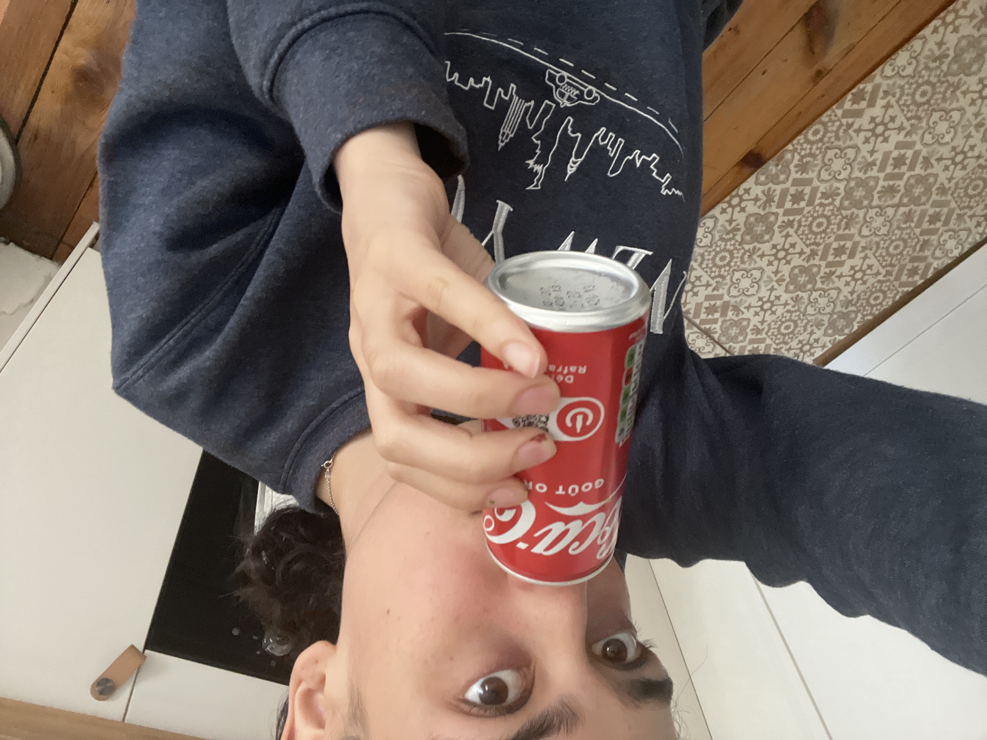 Person enjoys Coca-Cola and snacks in Lyon apartment