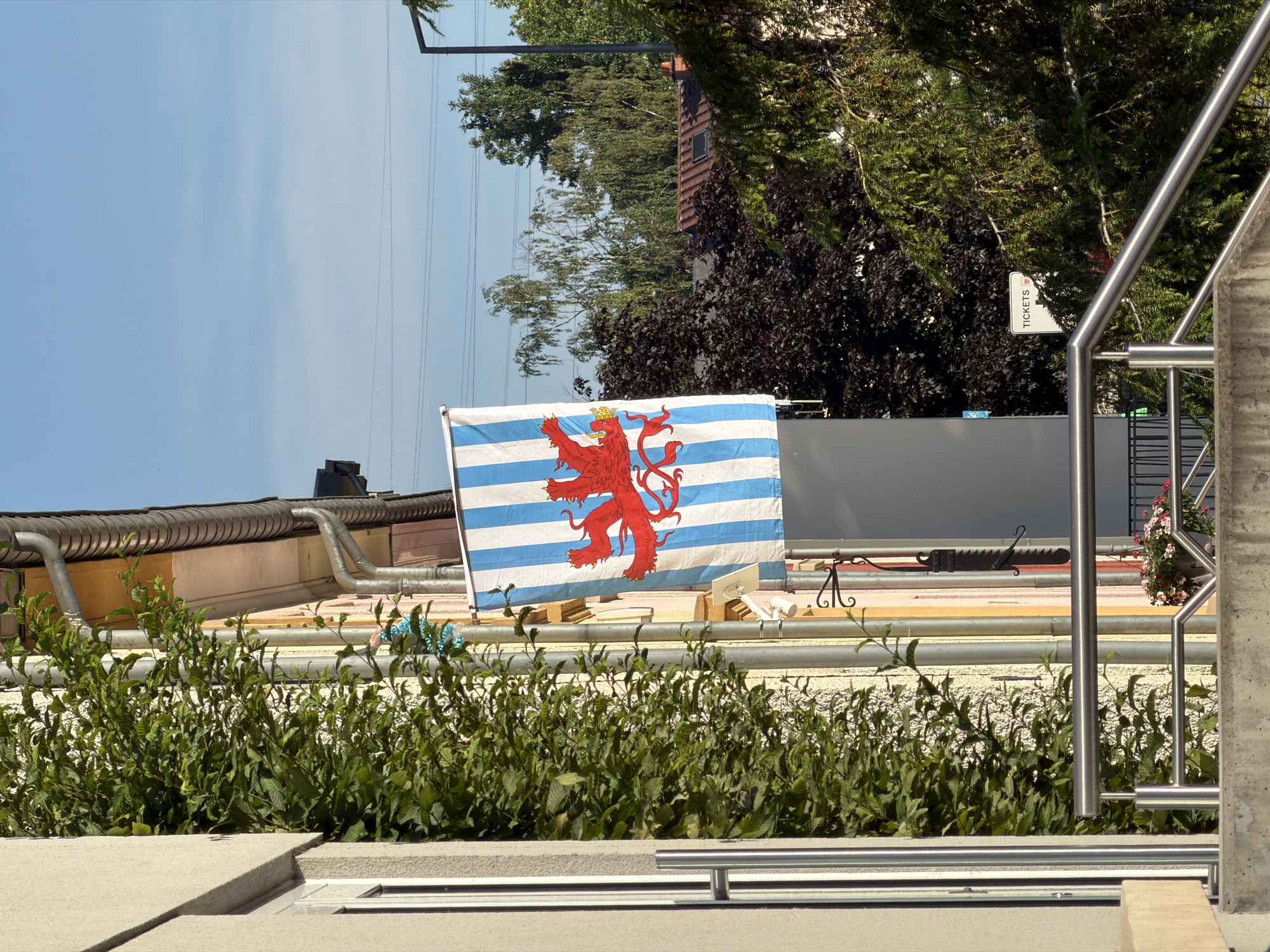 Flags flying on a pastel building in Esch-sur-Alzette