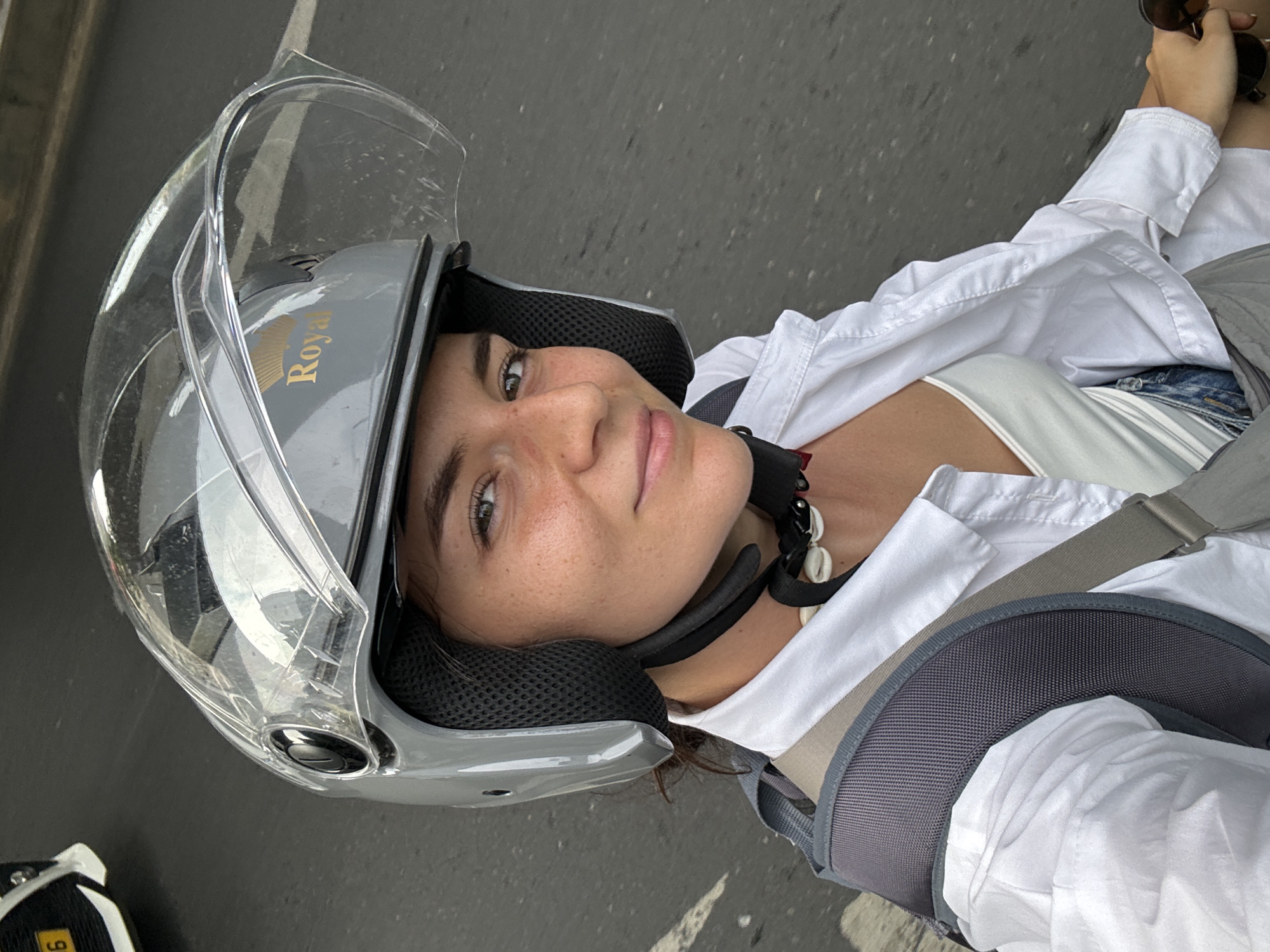 Woman in motorcycle helmet takes selfie in Thủ Đức