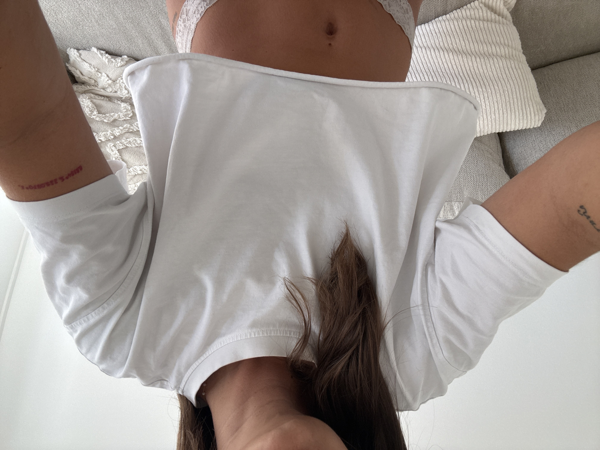 Person in white clothing observed relaxing indoors in Cannes