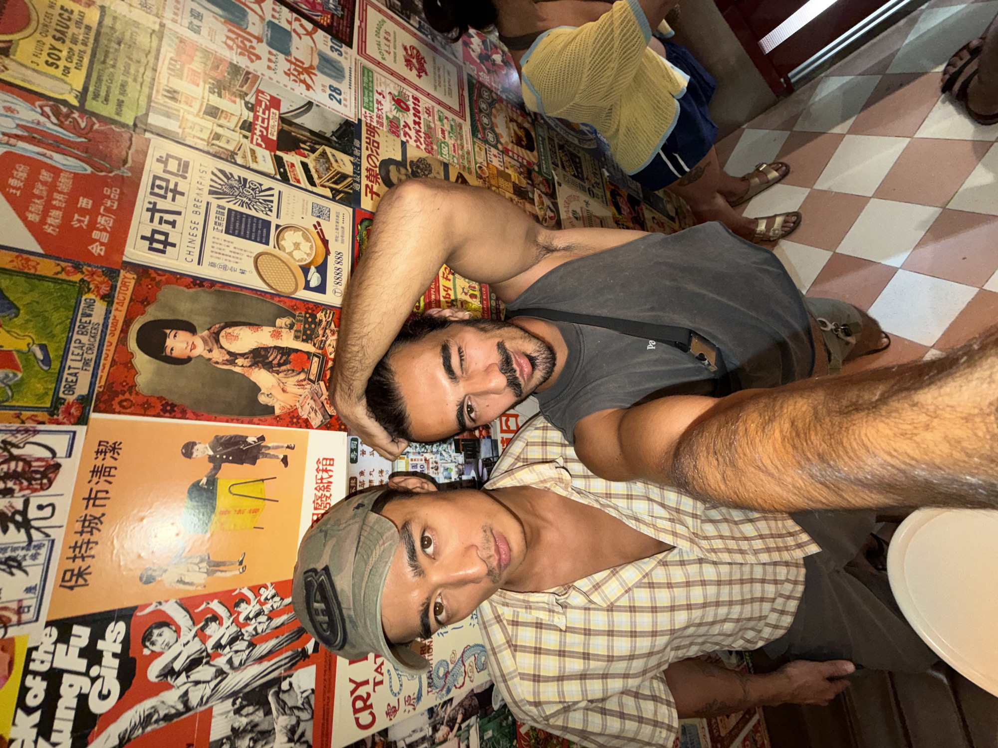 Tourists pose at vintage poster-decorated venue in Mengwi