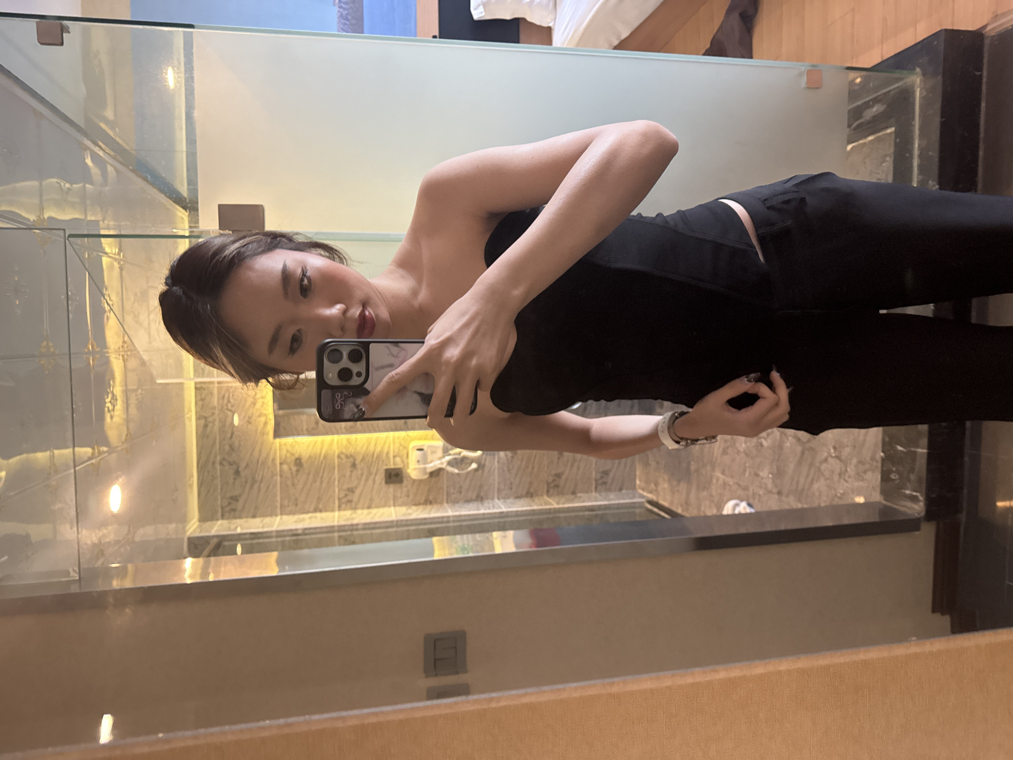 Woman takes mirror selfies in Ganzhou hotel bathroom