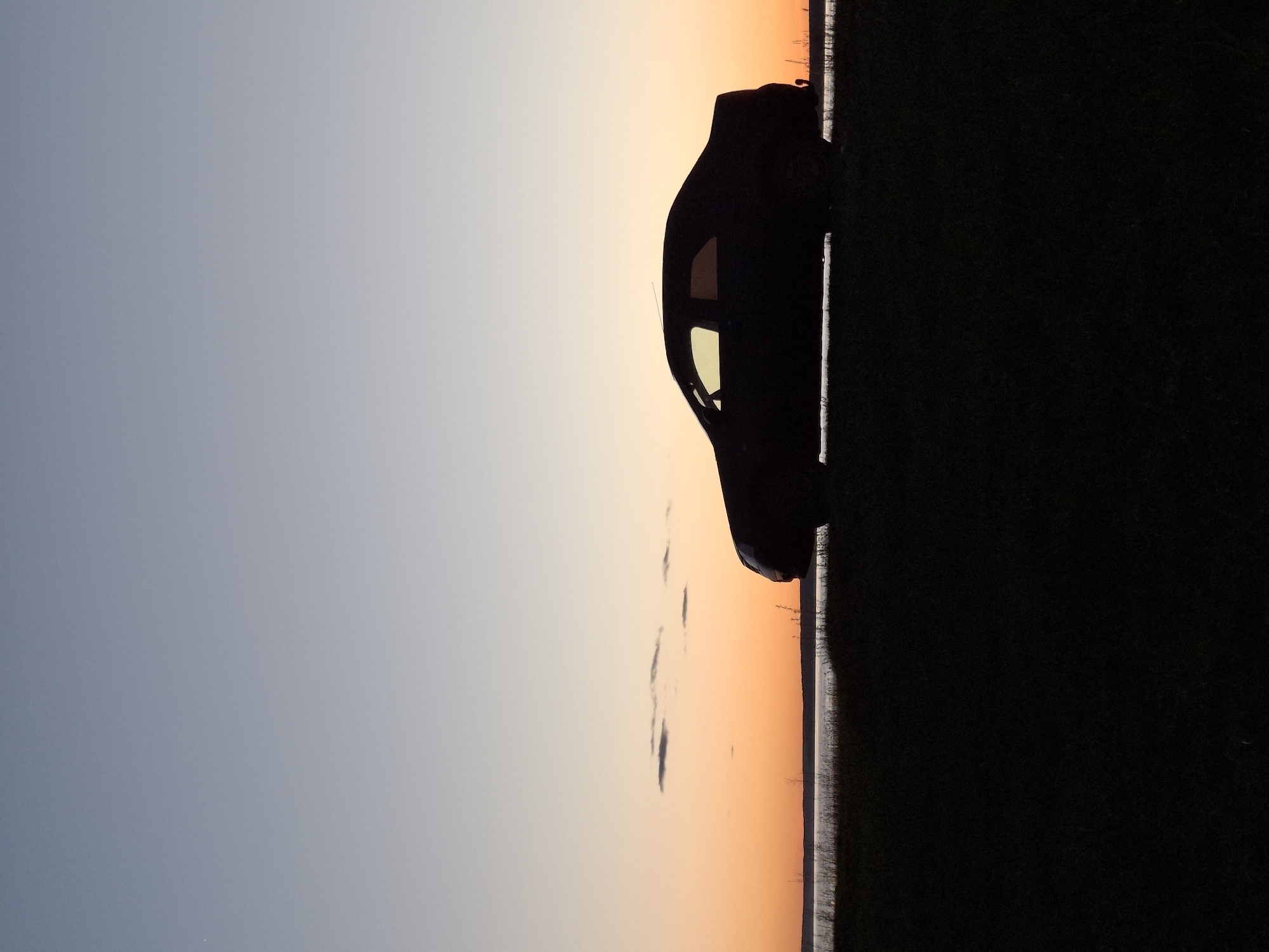 Car silhouetted against sunset sky in Plishkino, Russia