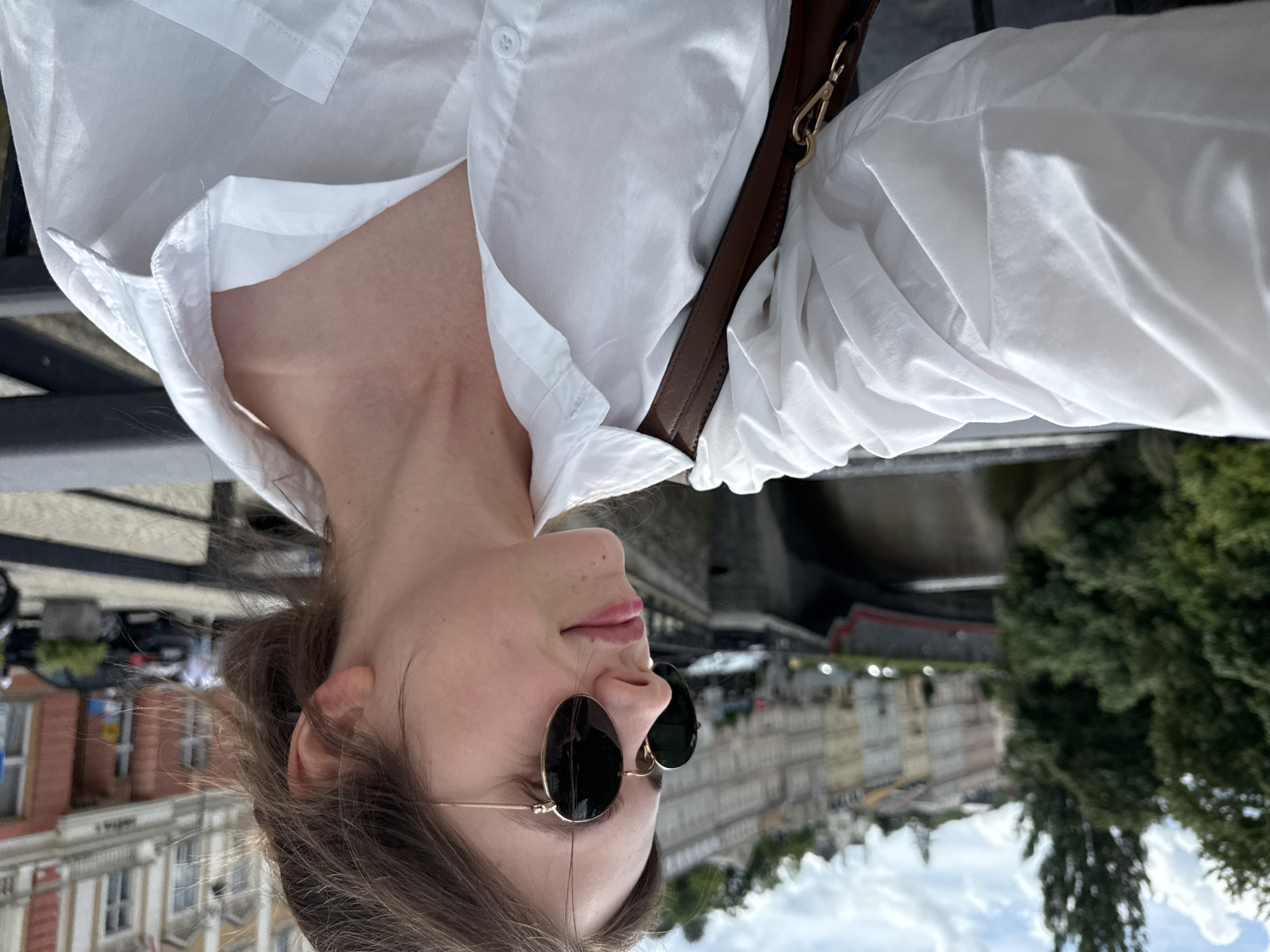 Tourist documents historic Karlovy Vary architecture during morning walkabout