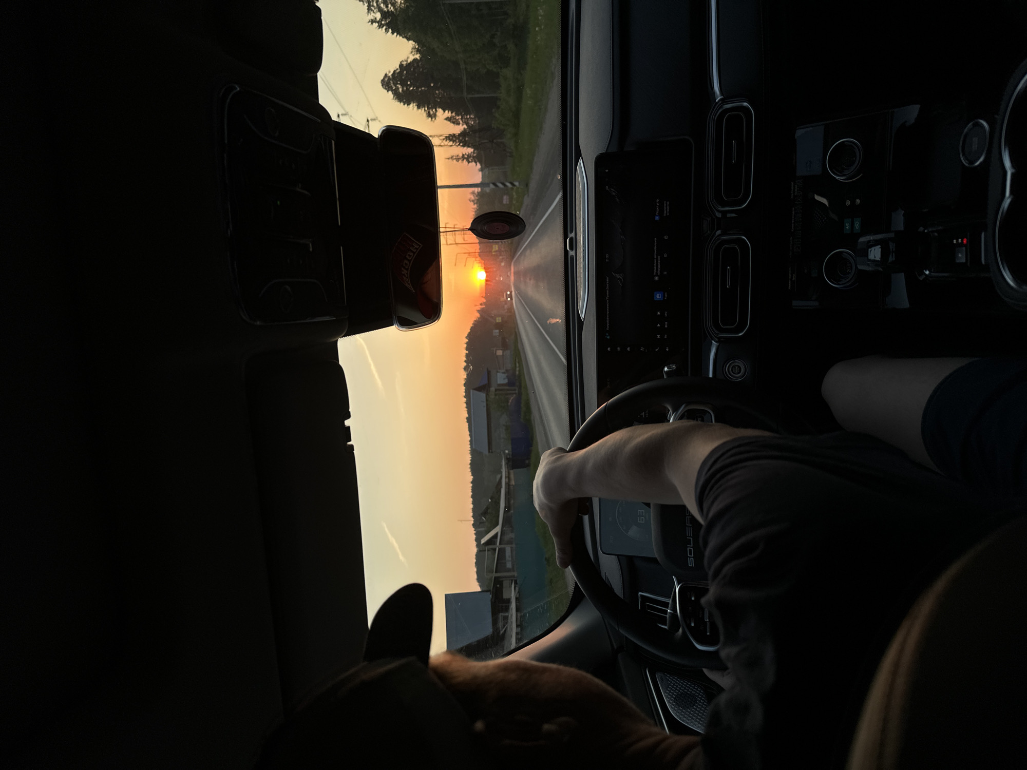 Driver captures sunset view on road near Chaikovsky