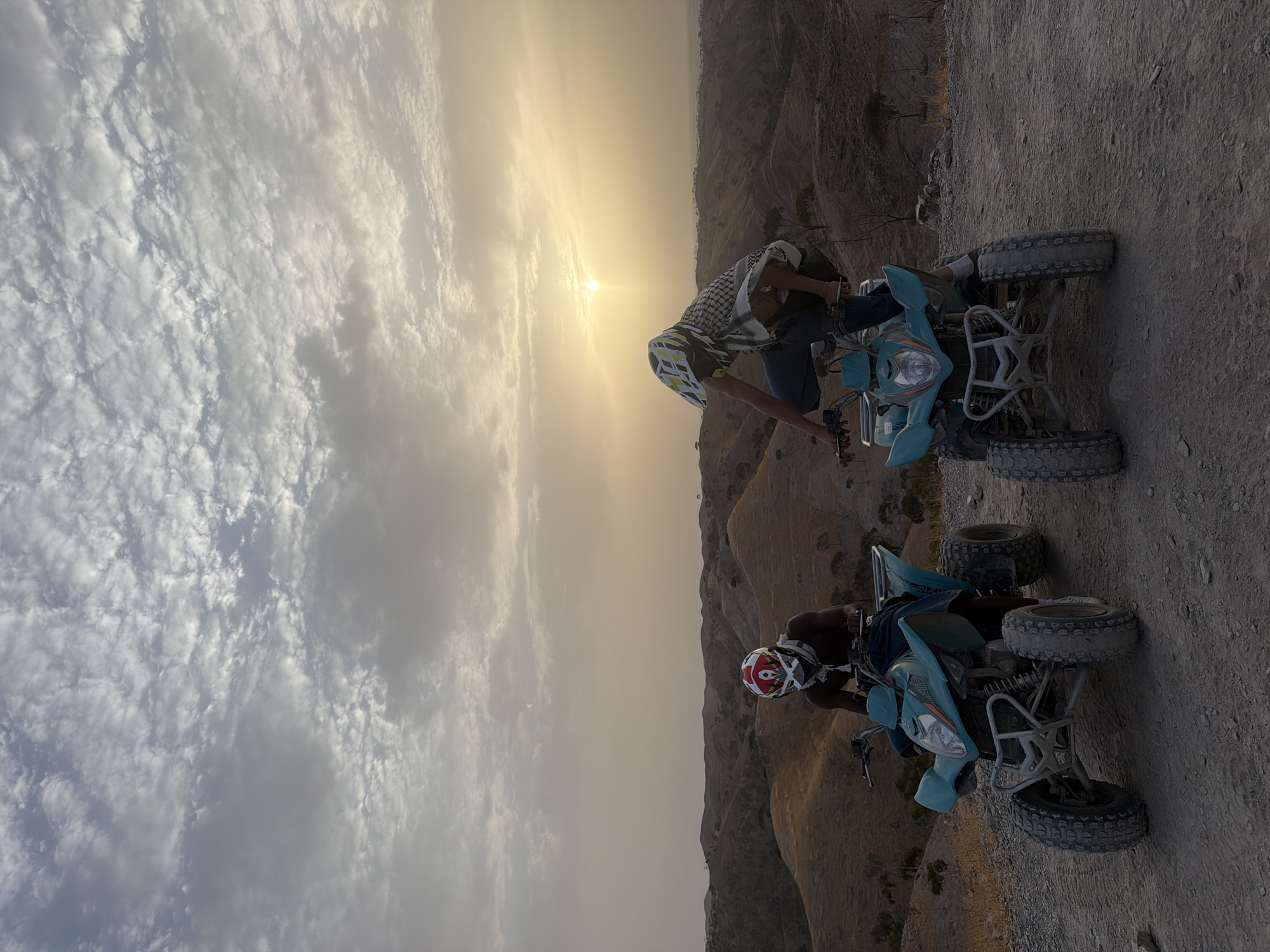 ATV riders pause at sunset in Morocco's rugged hills