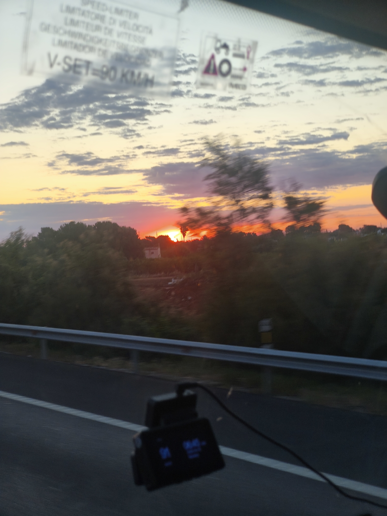 Colorful sunrise captured from vehicle near Valencia, Spain