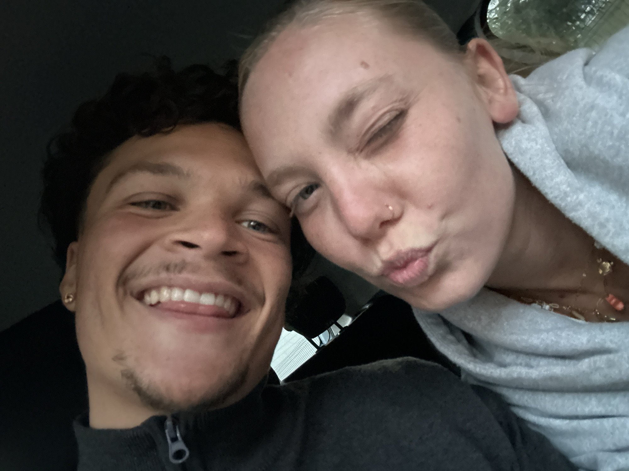 Young couple shares playful selfie moment in Lannoy car