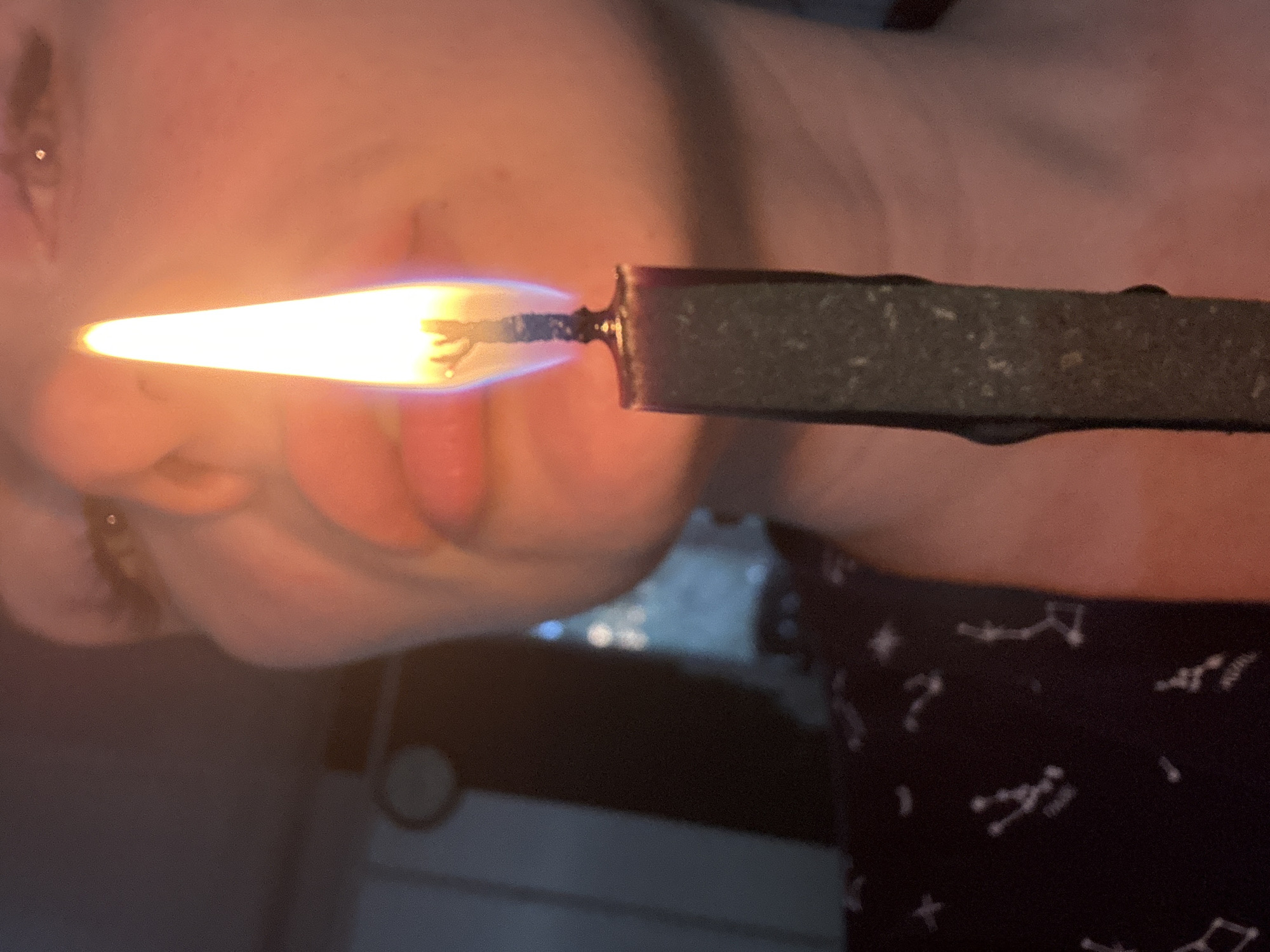 Person handles multiple burning objects in close-up photography session