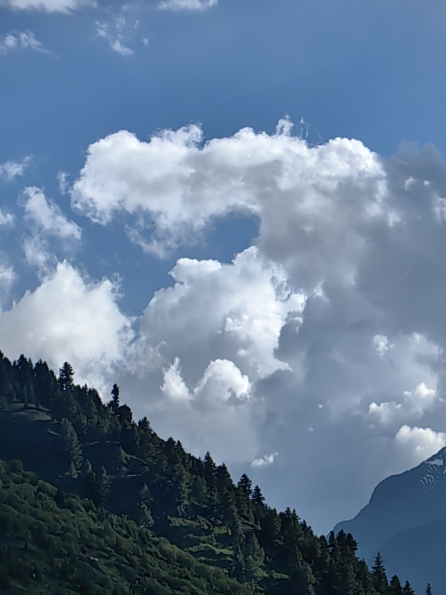 Keylang's Himalayan peaks, skies, and village on a June afternoon