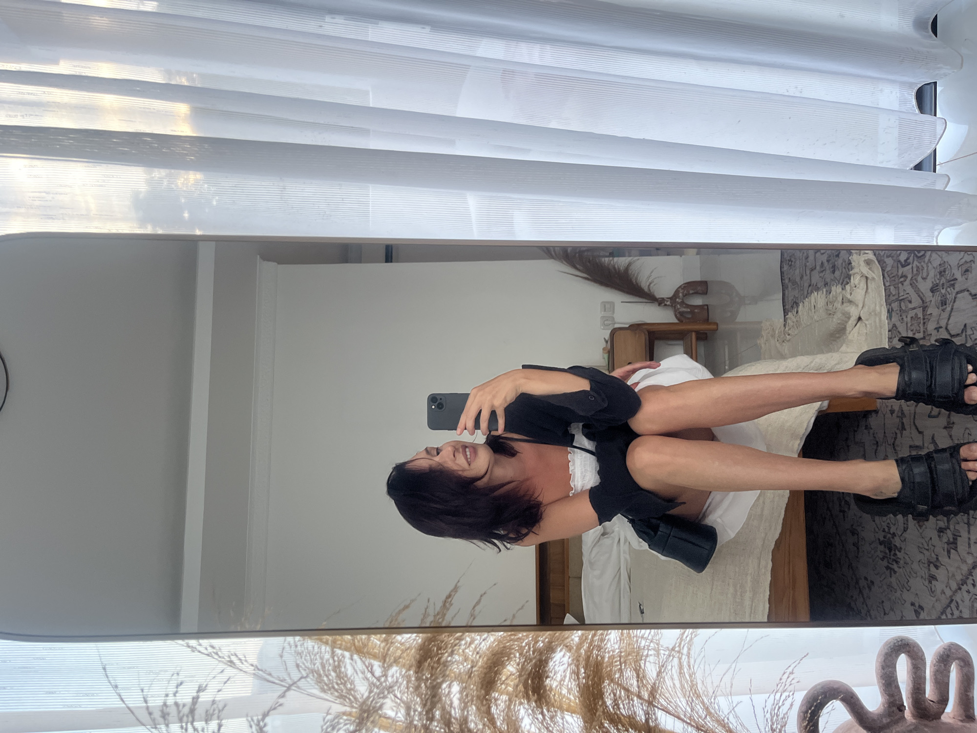 Woman takes mirror selfie in Kuta Selatan bedroom