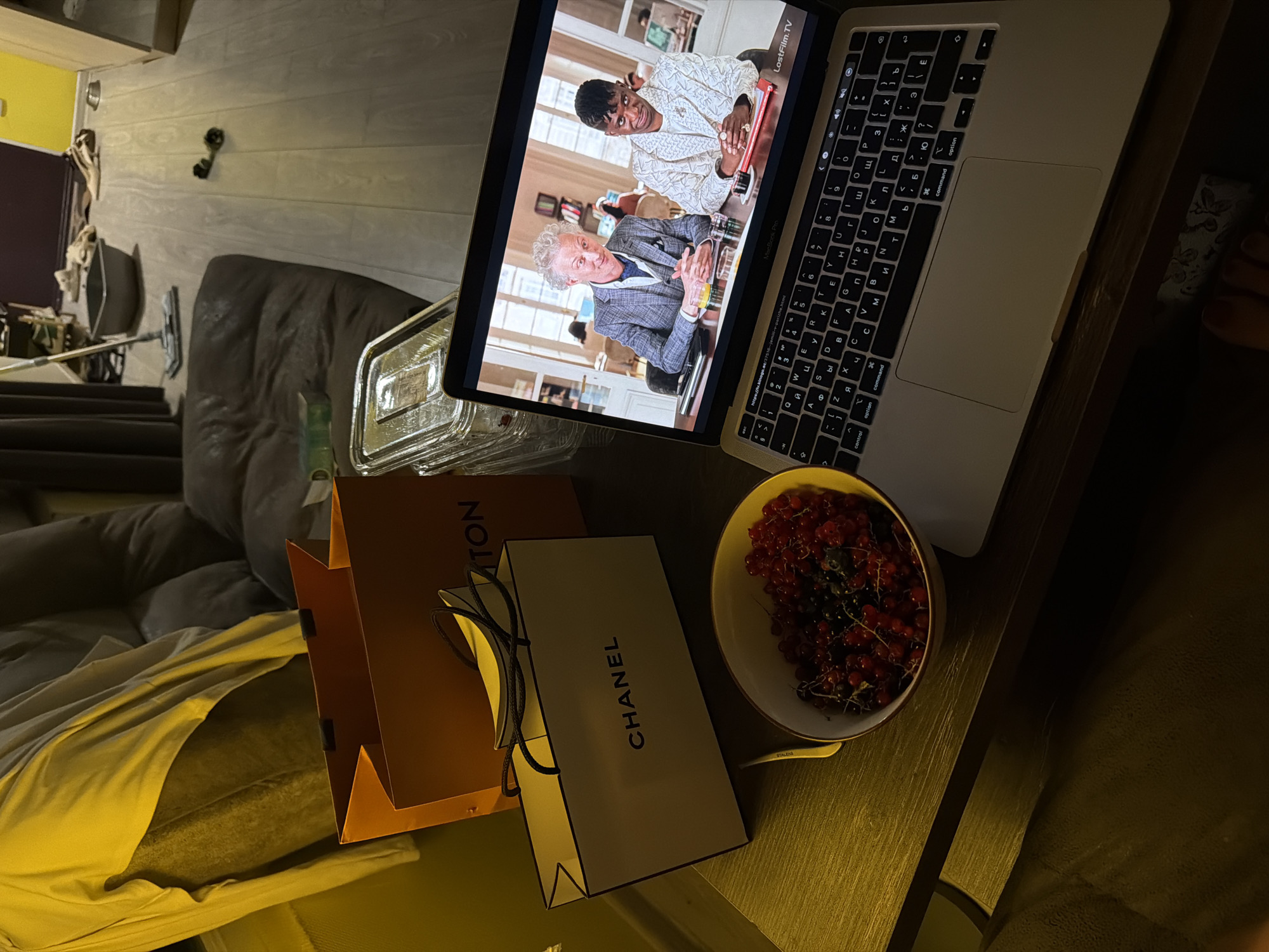 Laptop playing a video in a warmly lit Tbilisi room