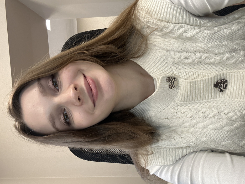 Woman takes morning selfies in cream cardigan in Kazan