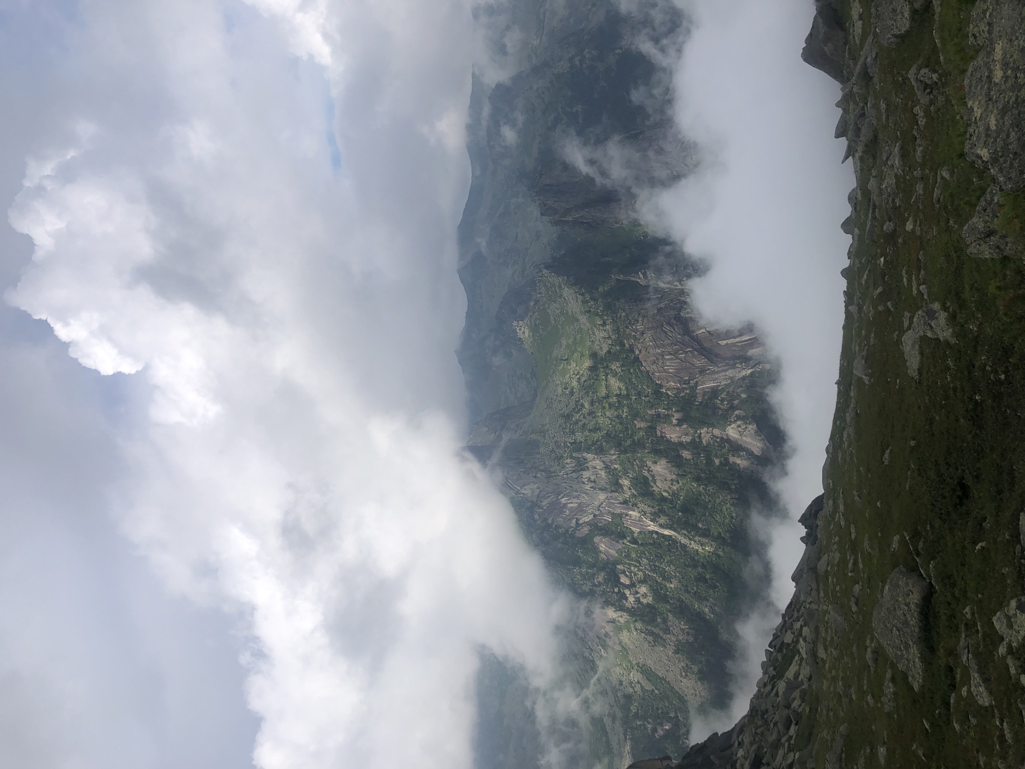 Hiking through cloud-covered rocky mountains in Russia
