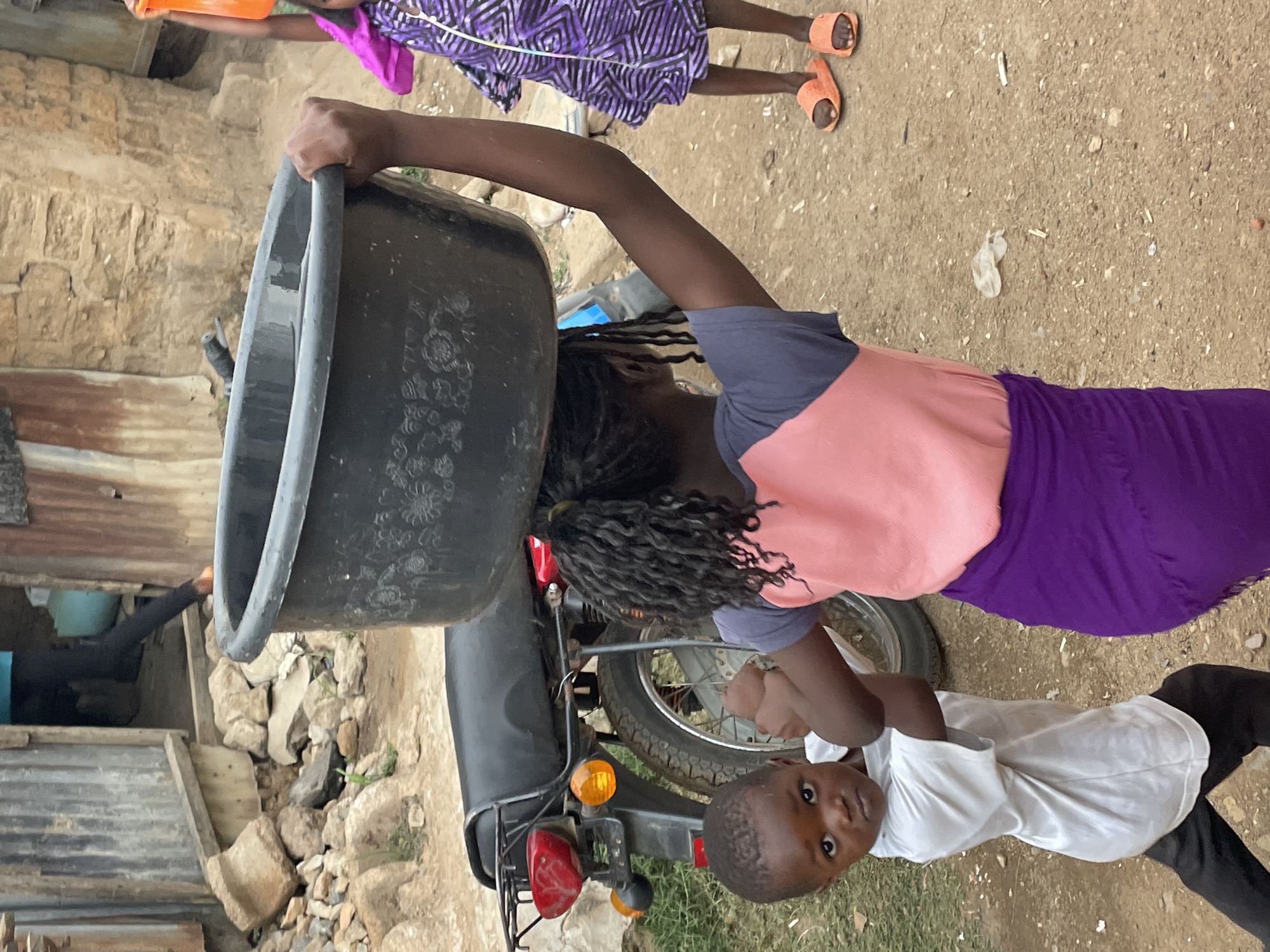 Daily life captured in Jos: children and vendors carrying goods