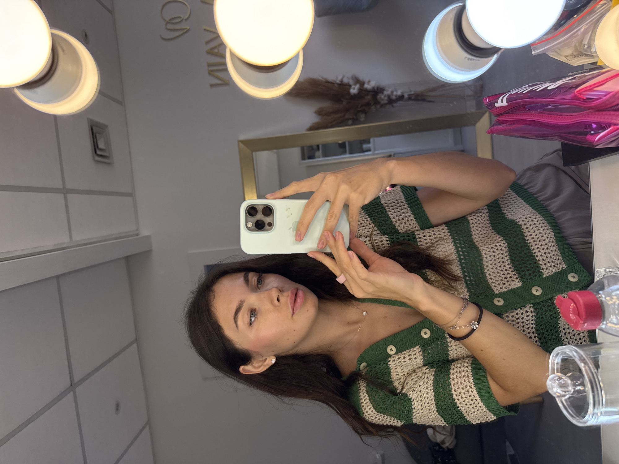 Mirror selfie in a Ramat Gan dressing room, striped cardigan