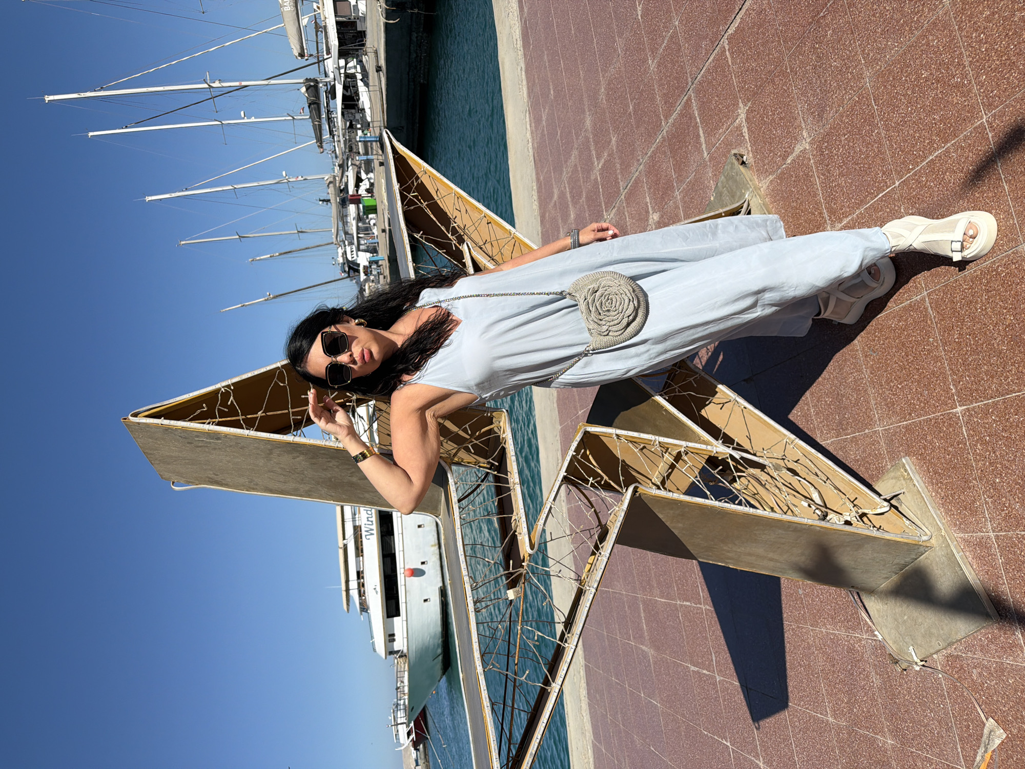 Tourist poses with star sculpture at Hurghada marina