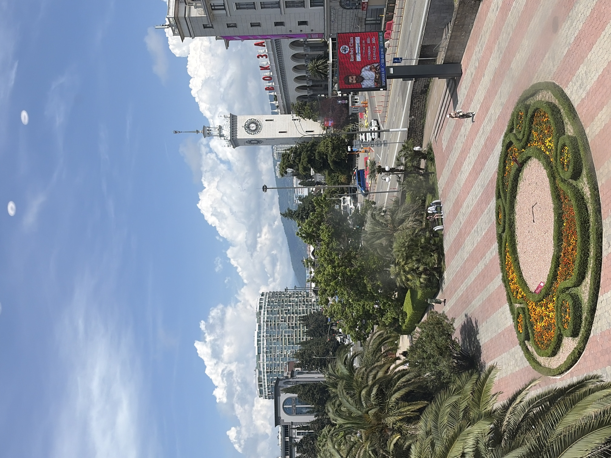 Individual documents Sochi landmarks and takes selfies during morning walkabout