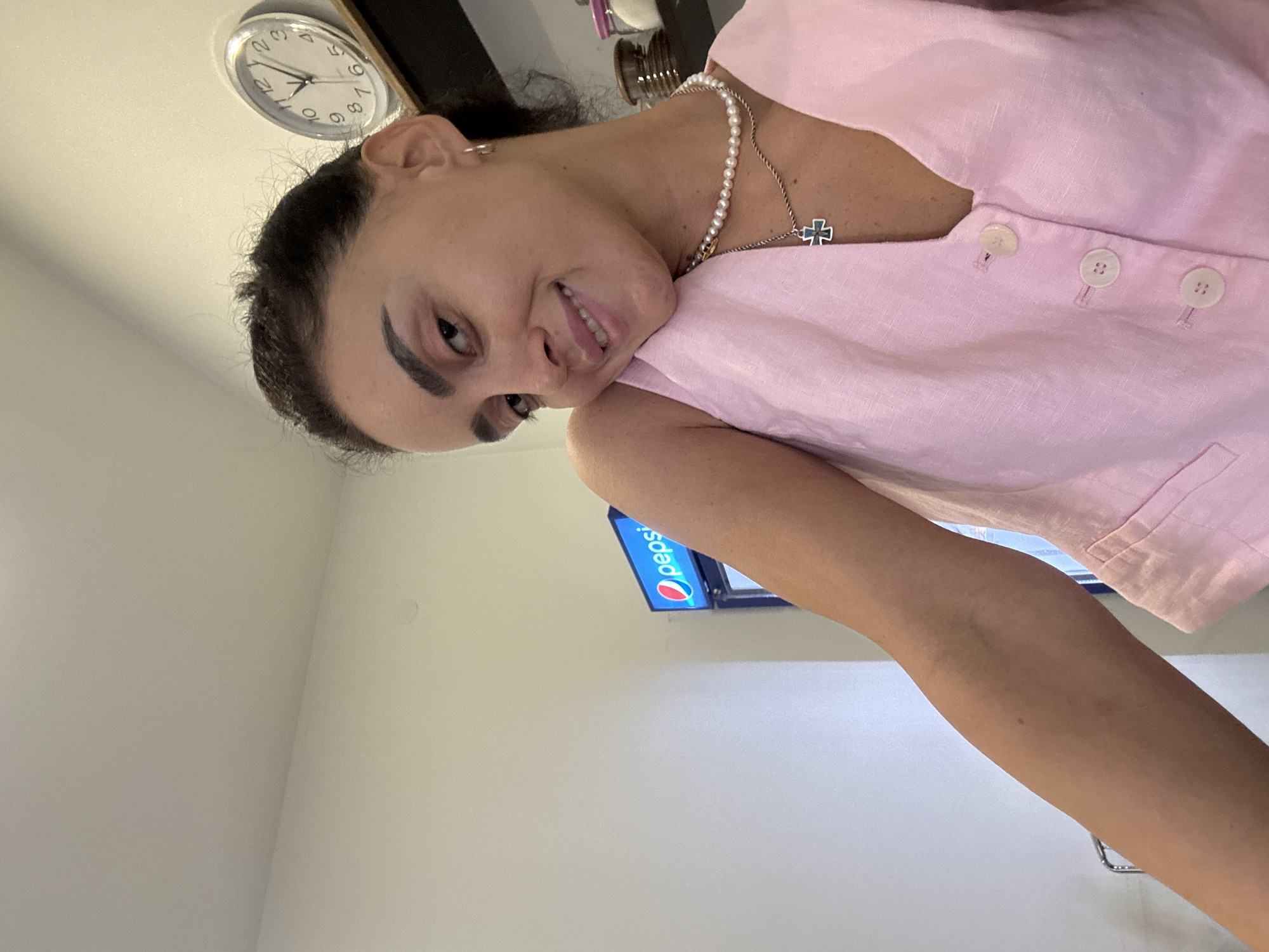 Indoor selfie in Tbilisi, pink top and pearl necklace
