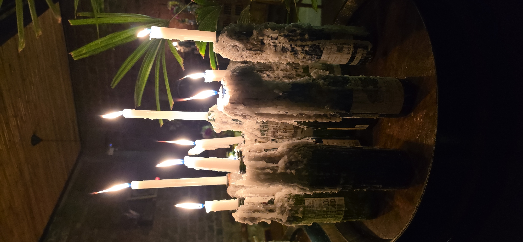 Candlelit interior with wax-covered wine bottles, Punta Hermosa