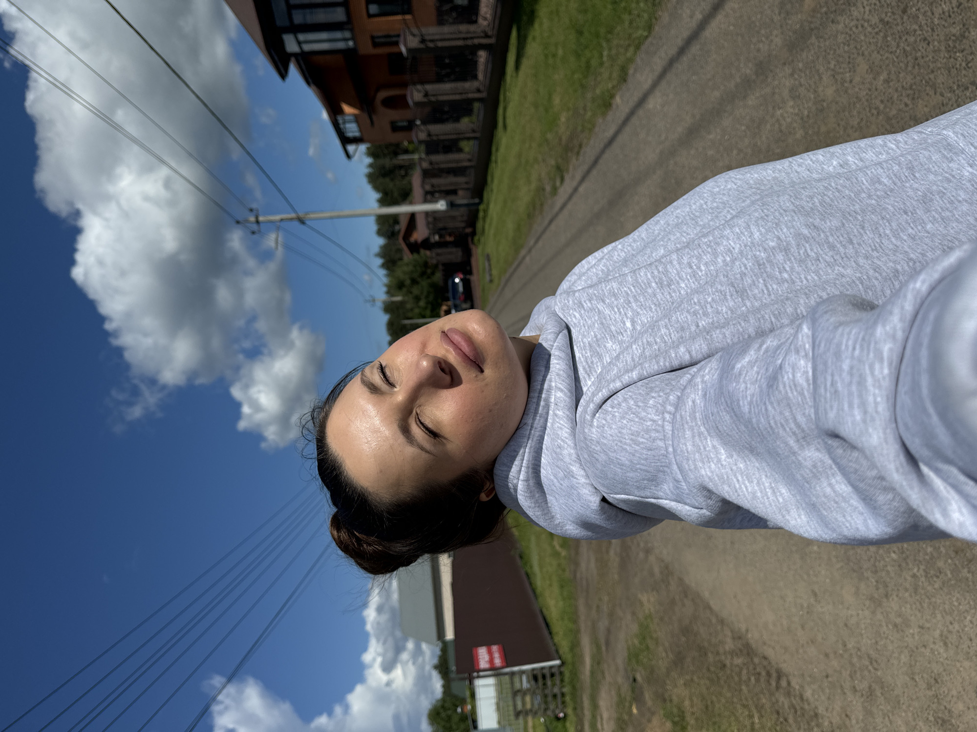 Woman takes selfie on road in Vysokinichi, Russia