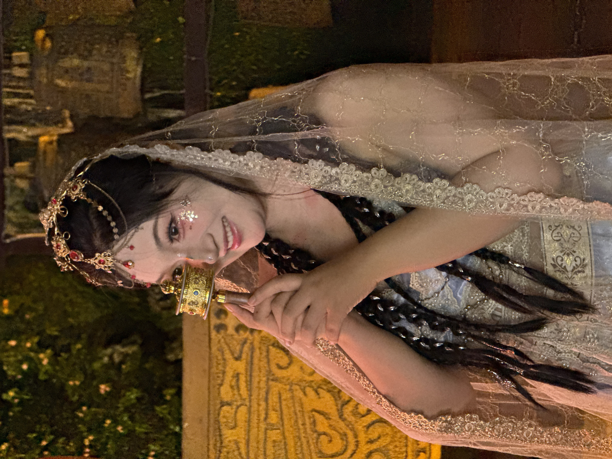 Woman in ceremonial dress holds drum in Yuzhong District