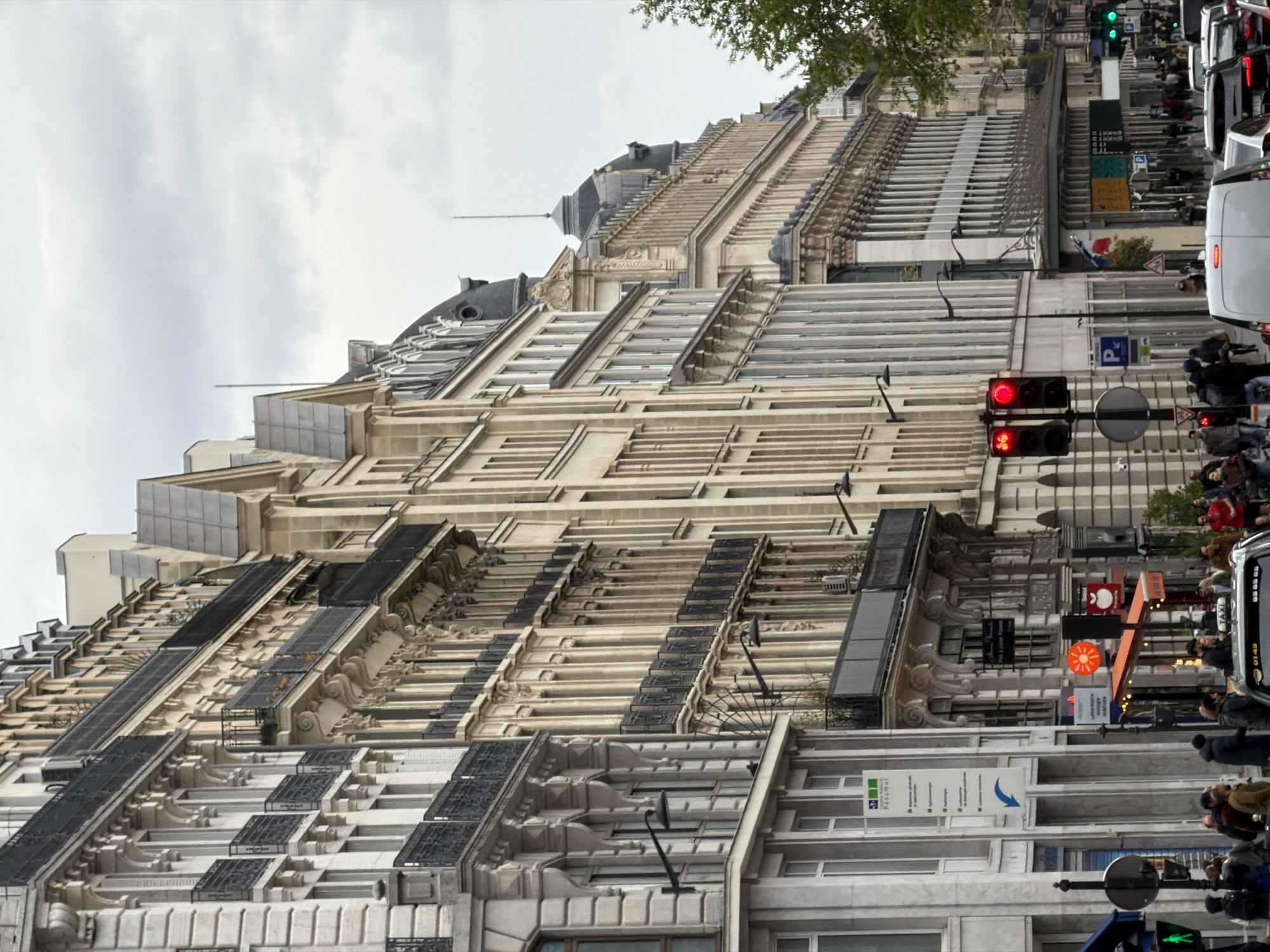 Pedestrians navigate Paris streets during afternoon rush hour