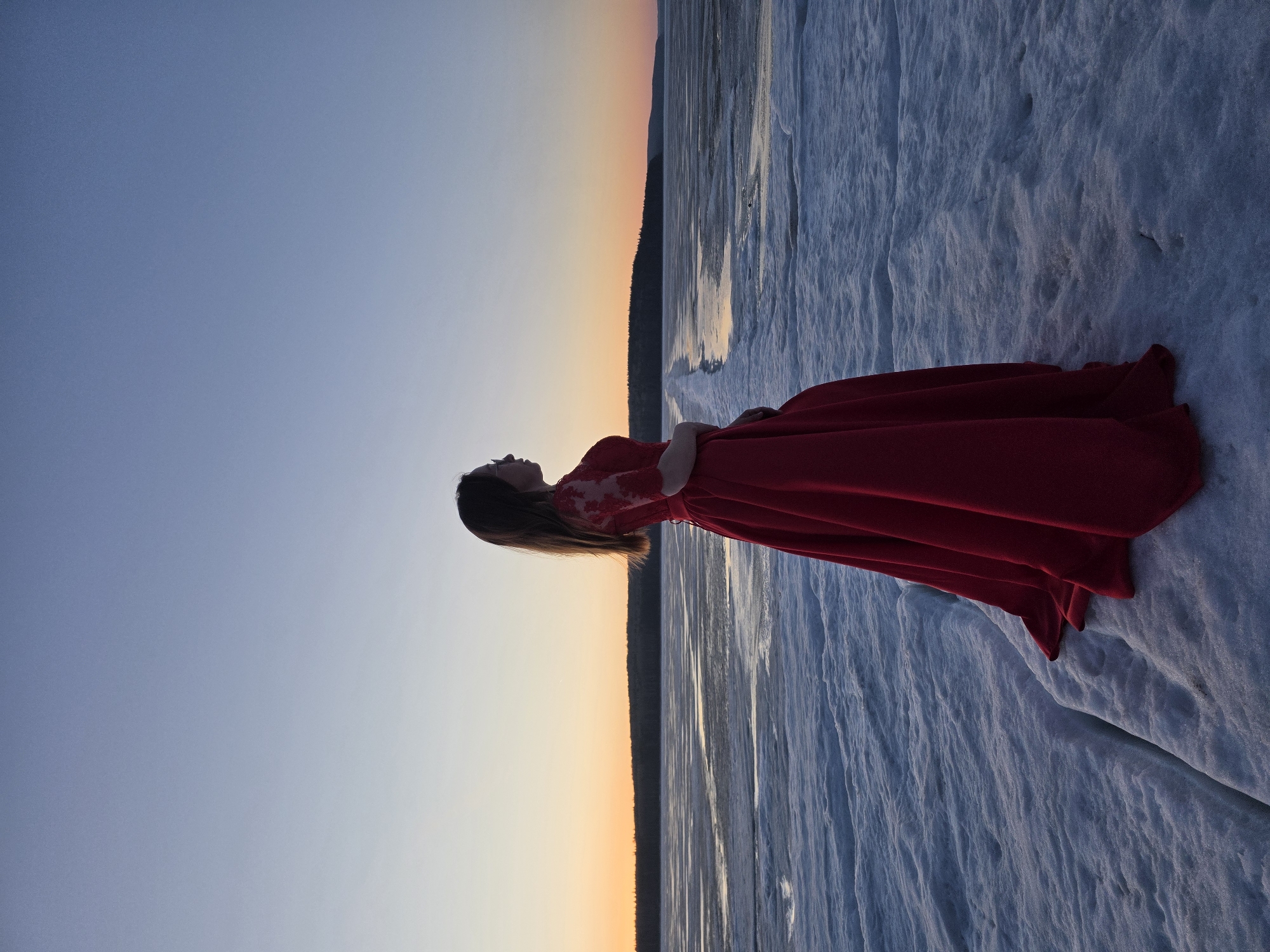 Woman in red dress photographed at sunset in Chaikovsky