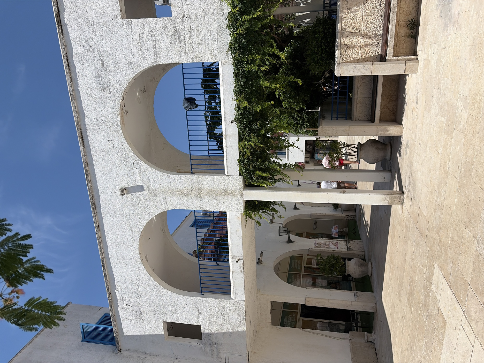 Morning stroll through sunny Budva captures Mediterranean architecture and beach life