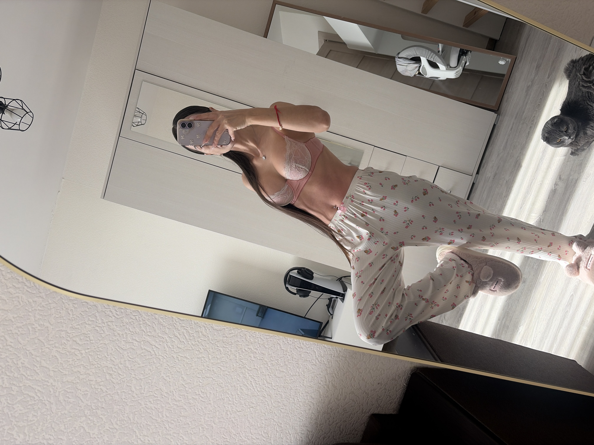 Woman takes morning selfies with gray cat in Saint Petersburg