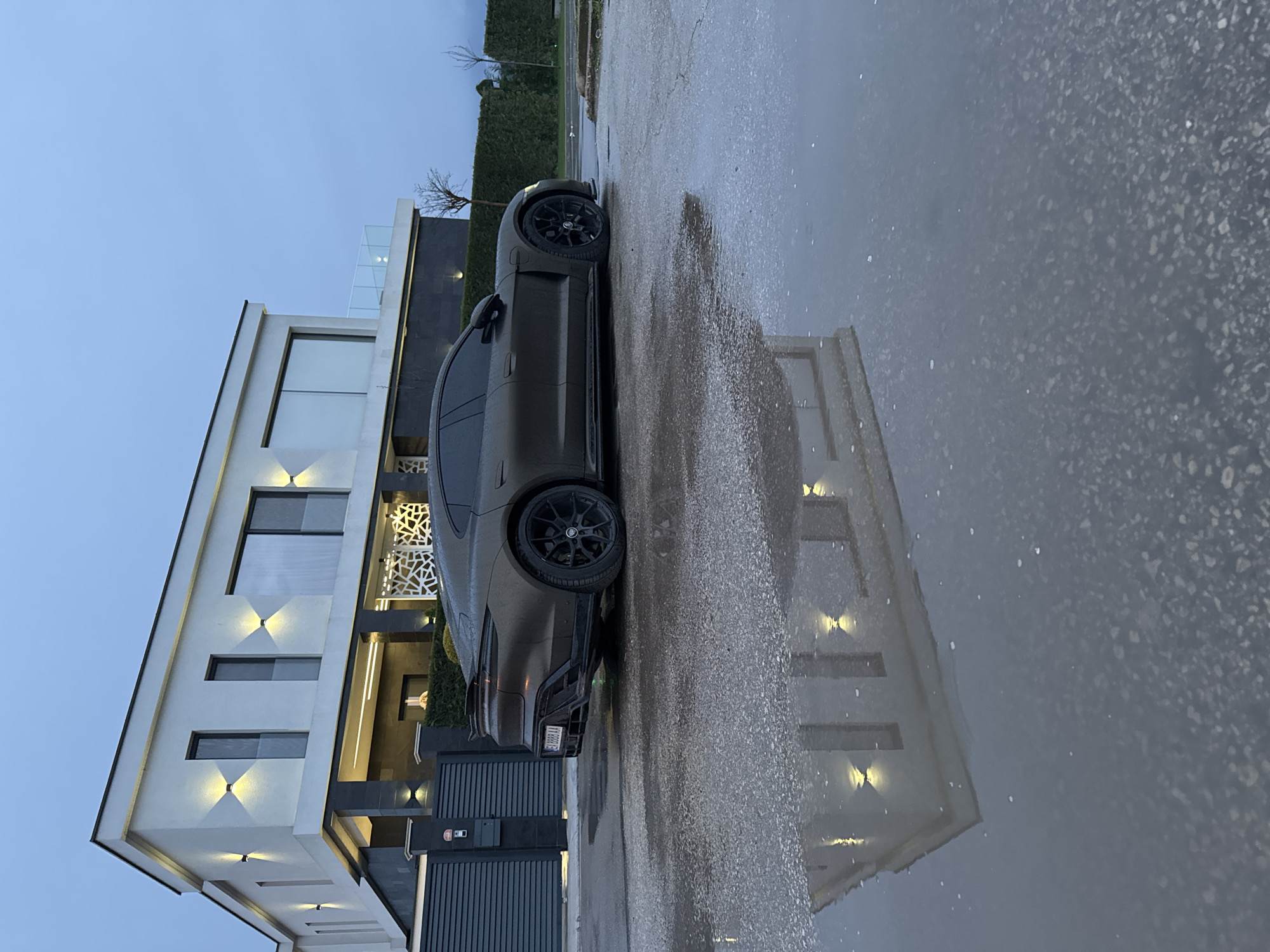 Gray Porsche parked on wet street in Kazashko, Bulgaria