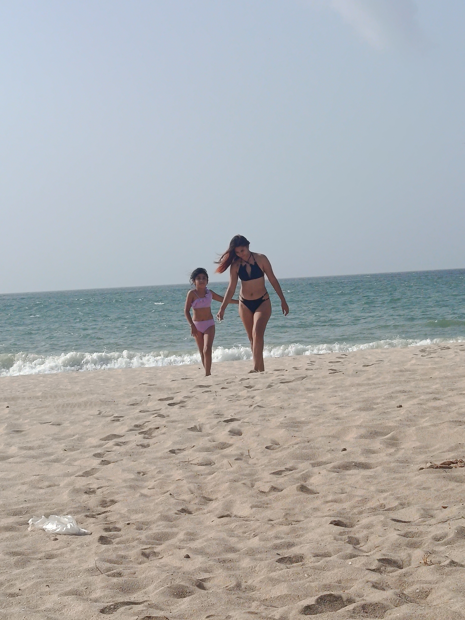 Woman and child enjoy evening beach time in Venezuela