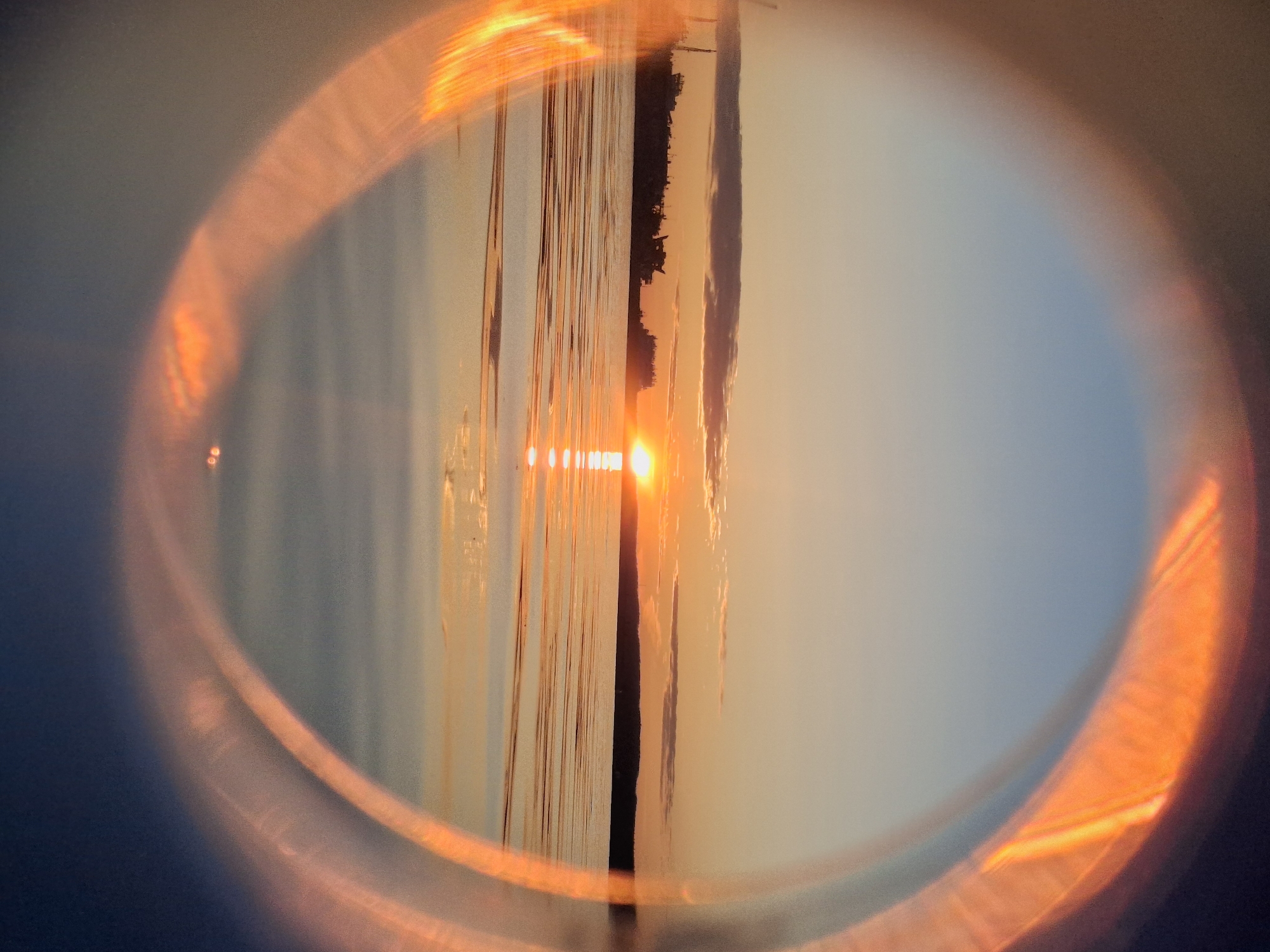 Sunset over Kama River observed through makeshift lens in Chaikovsky