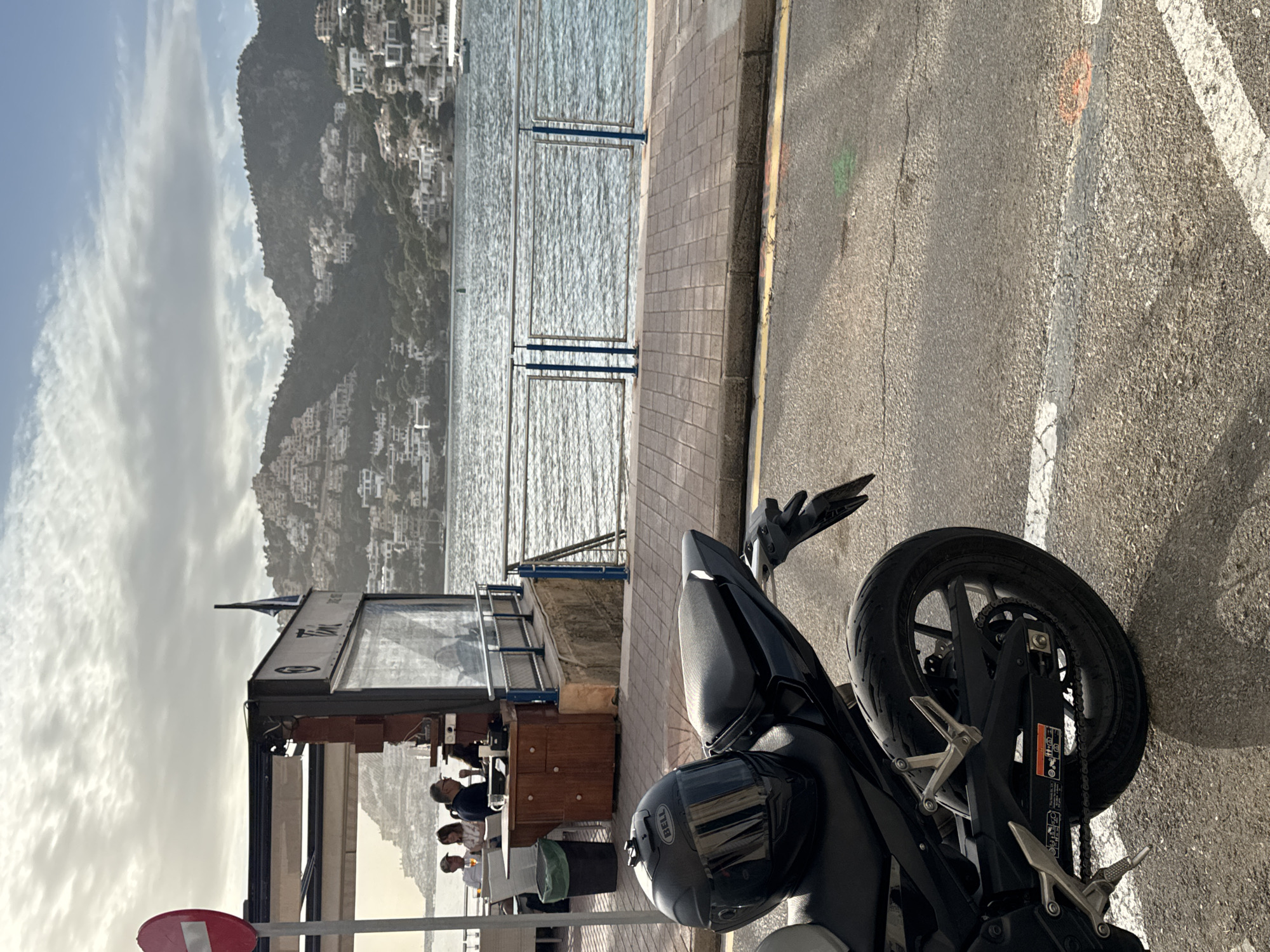 Motorcycle parked outside dining kiosk in Andratx Spain