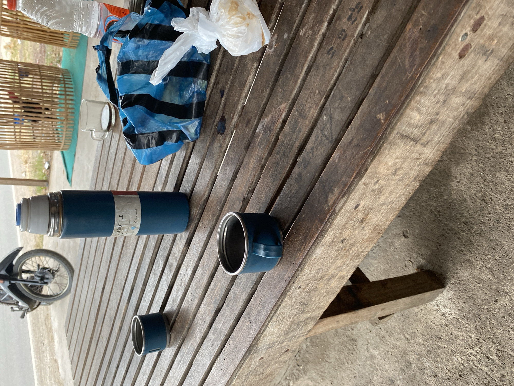 Casual outdoor rest stop around a wooden table in Bayu