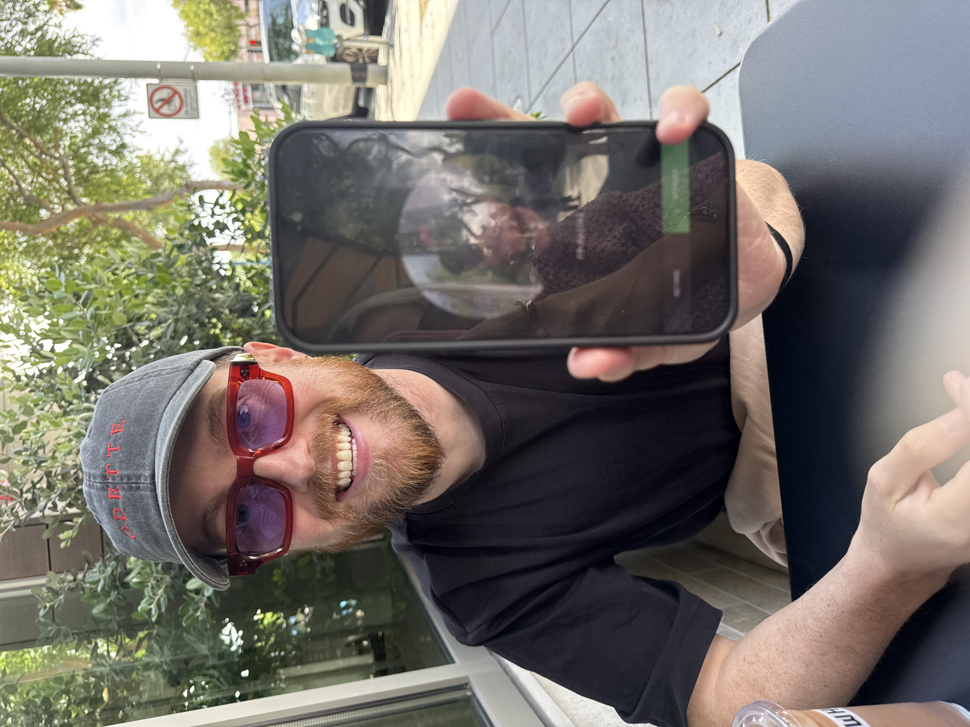 Man with smartphone, Erewhon drinks photographed in West Hollywood