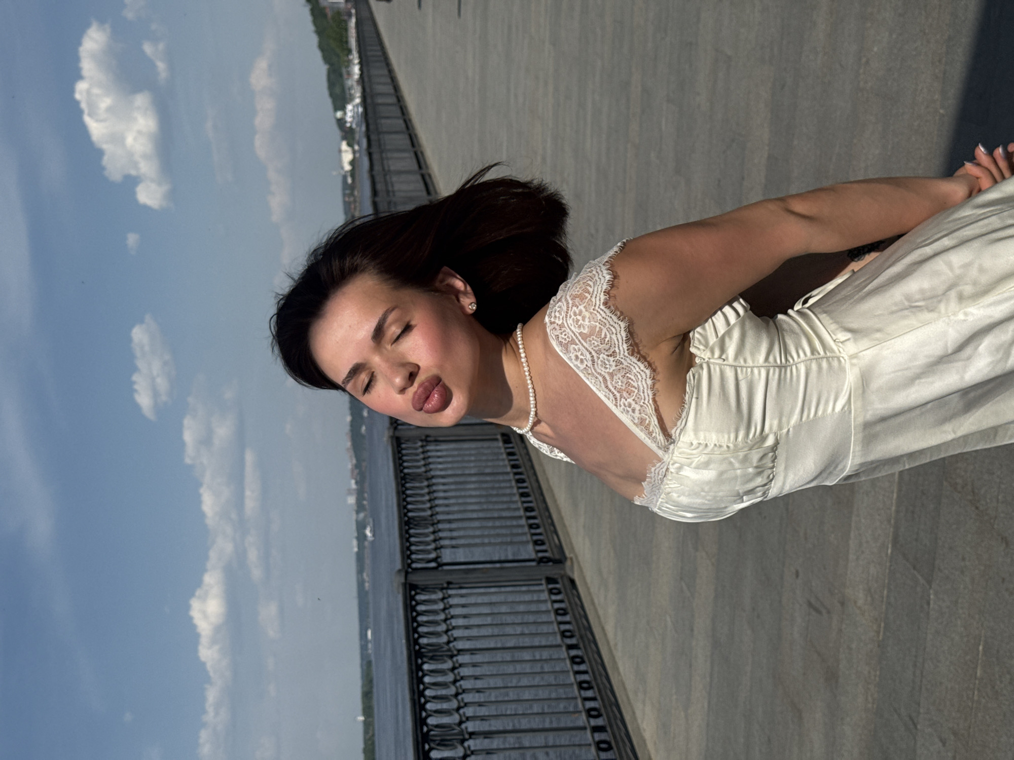 Woman poses for photos along Perm waterfront promenade