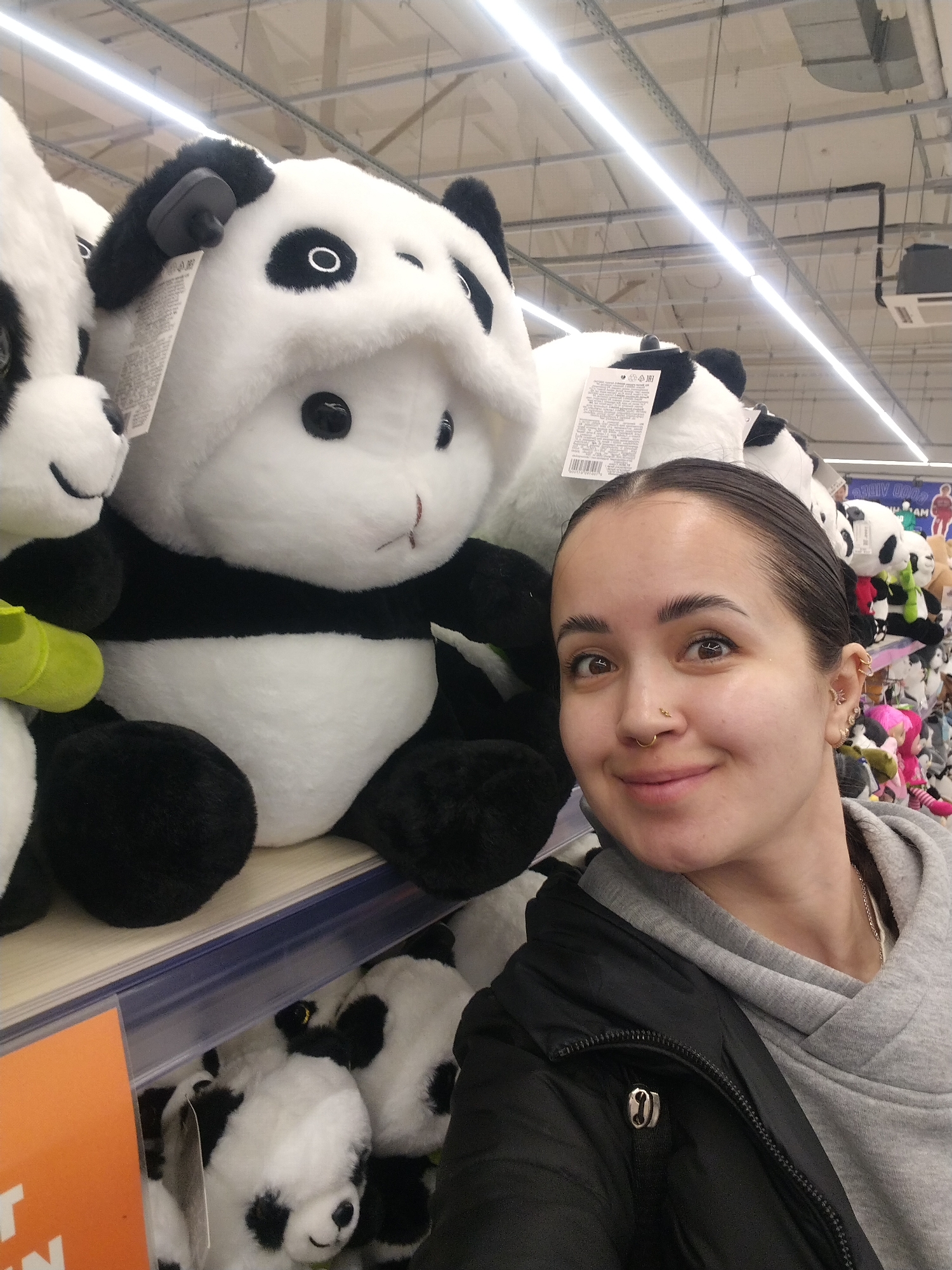 Woman takes panda selfie, child plays in hammock seat