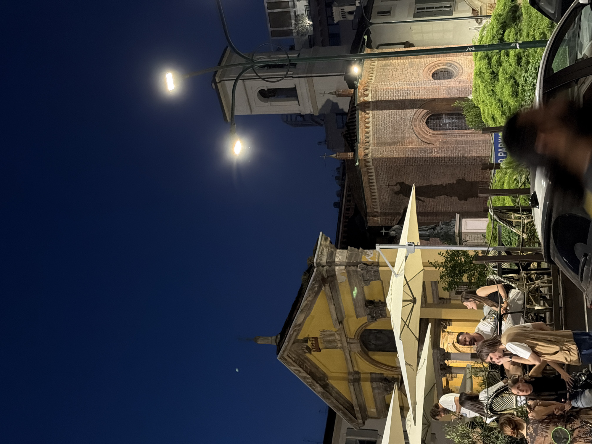 Evening outdoor dining scene documented in Milan, Italy