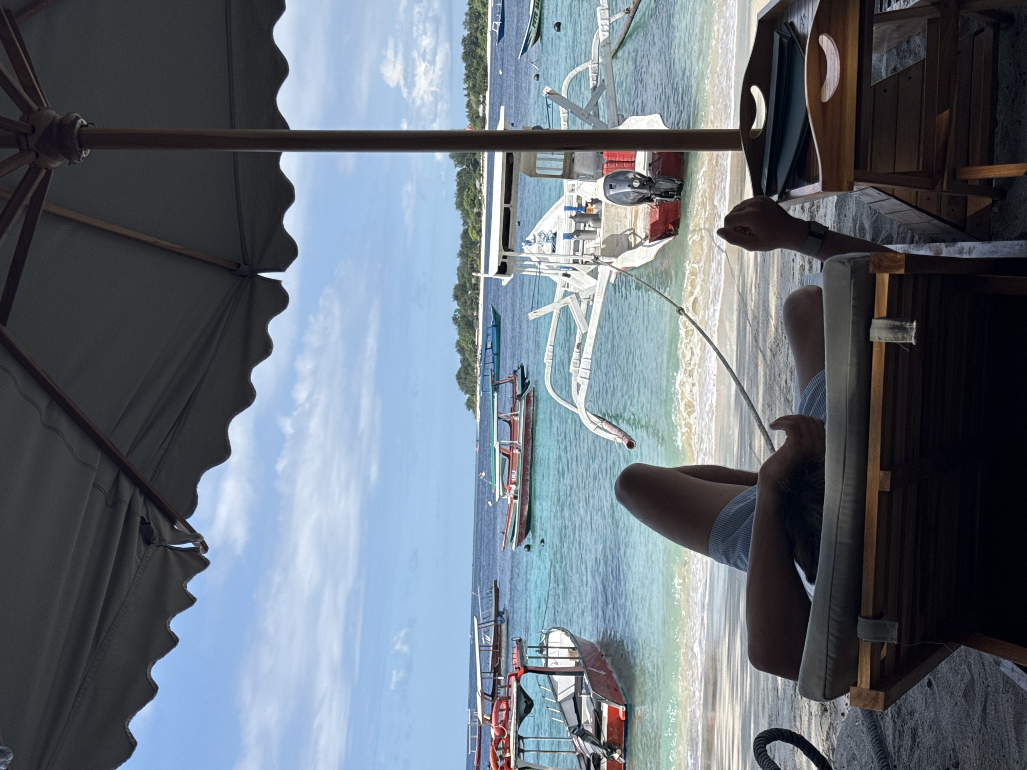 Morning boats captured from Indonesian beachside umbrella perspective